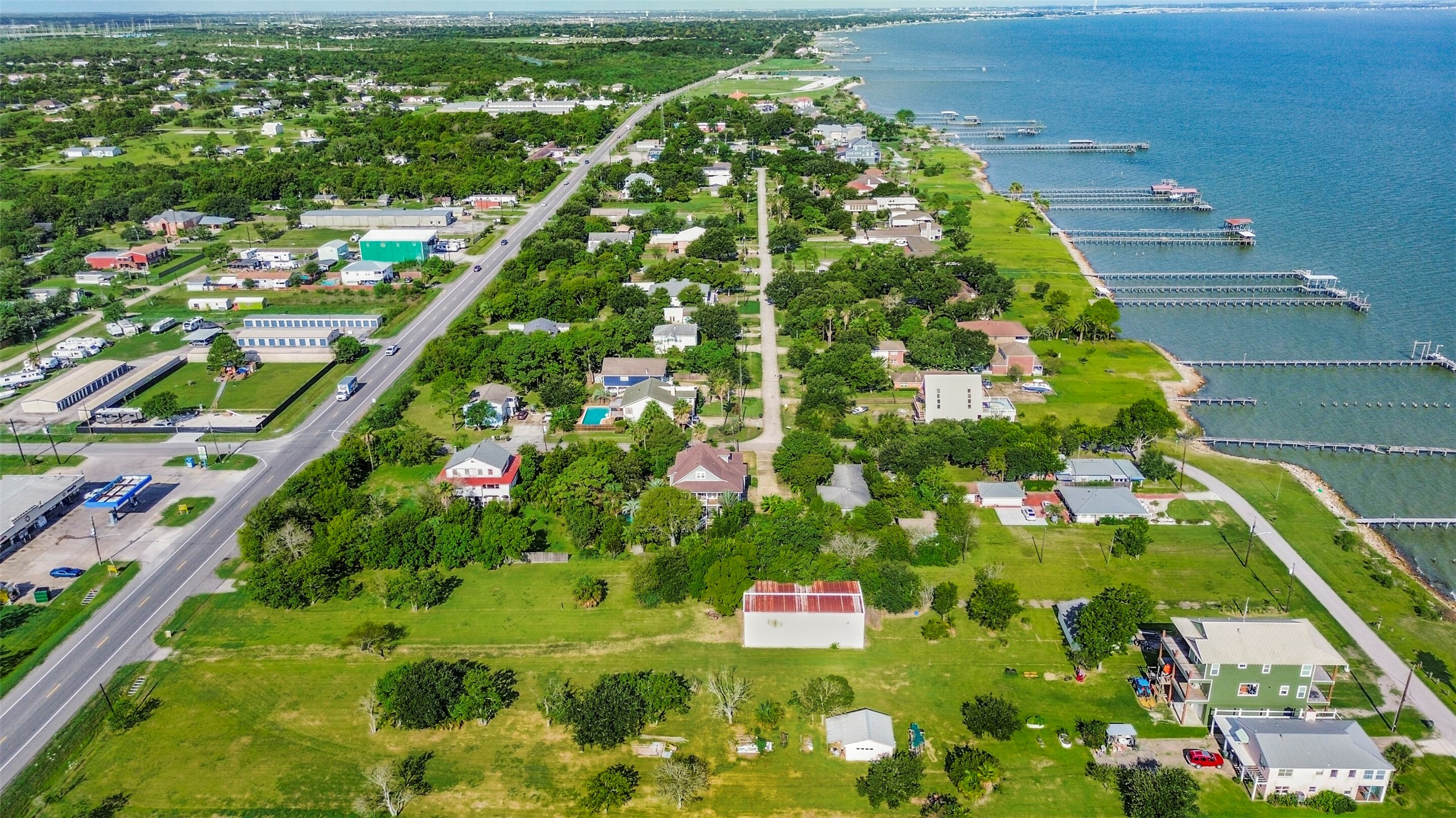 Charming coastal neighborhood with lush greenery and direct water access, offering picturesque views and serene living by the bay.