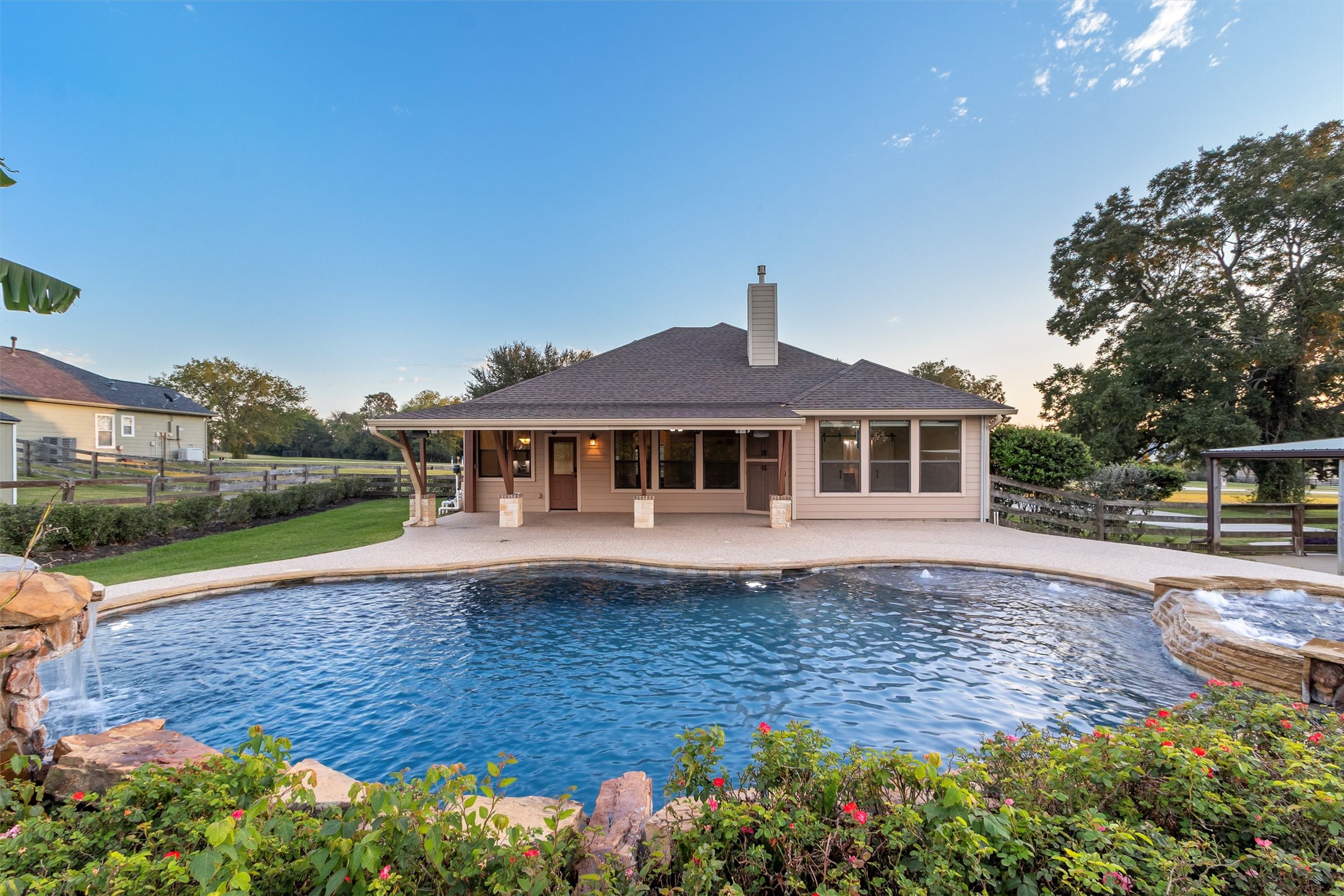 Your Very Own Backyard Paradise! Dive into luxury with this stunning resort-style pool featuring beautiful rock waterfalls, a relaxing hot tub, and lush landscaping! The expansive covered patio offers the perfect setting for outdoor entertaining, while the spacious 1-acre property and no back neighbors provide added privacy. Every day feels like a vacation in your own backyard!