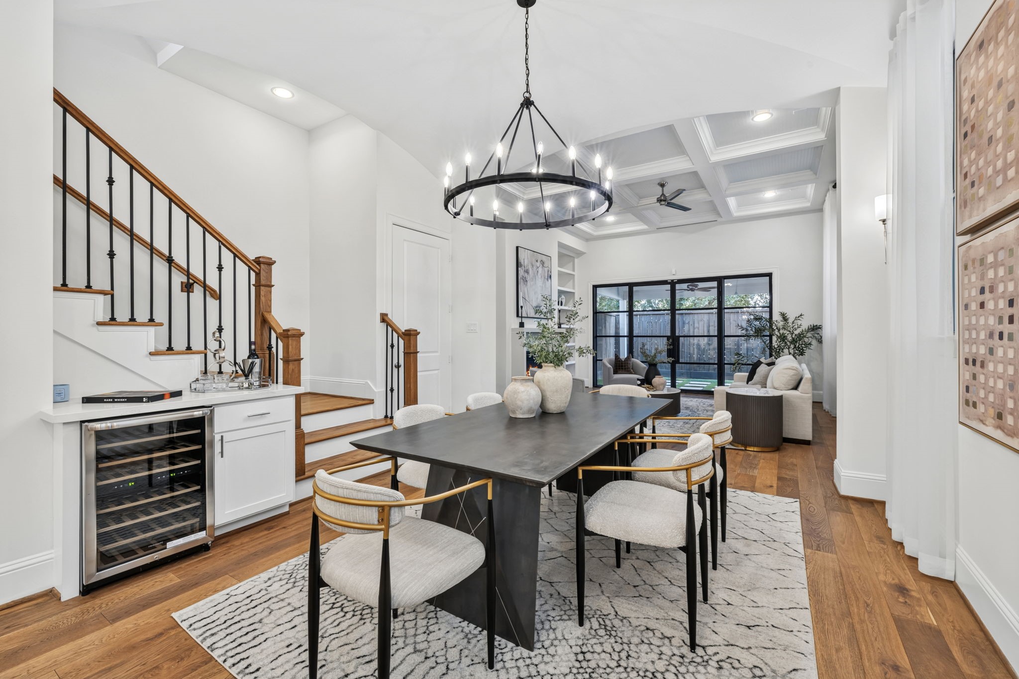 Stunning first floor living featuring custom iron glass doors that open wide to the patio for seamless indoor-outdoor living and effortless entertaining.