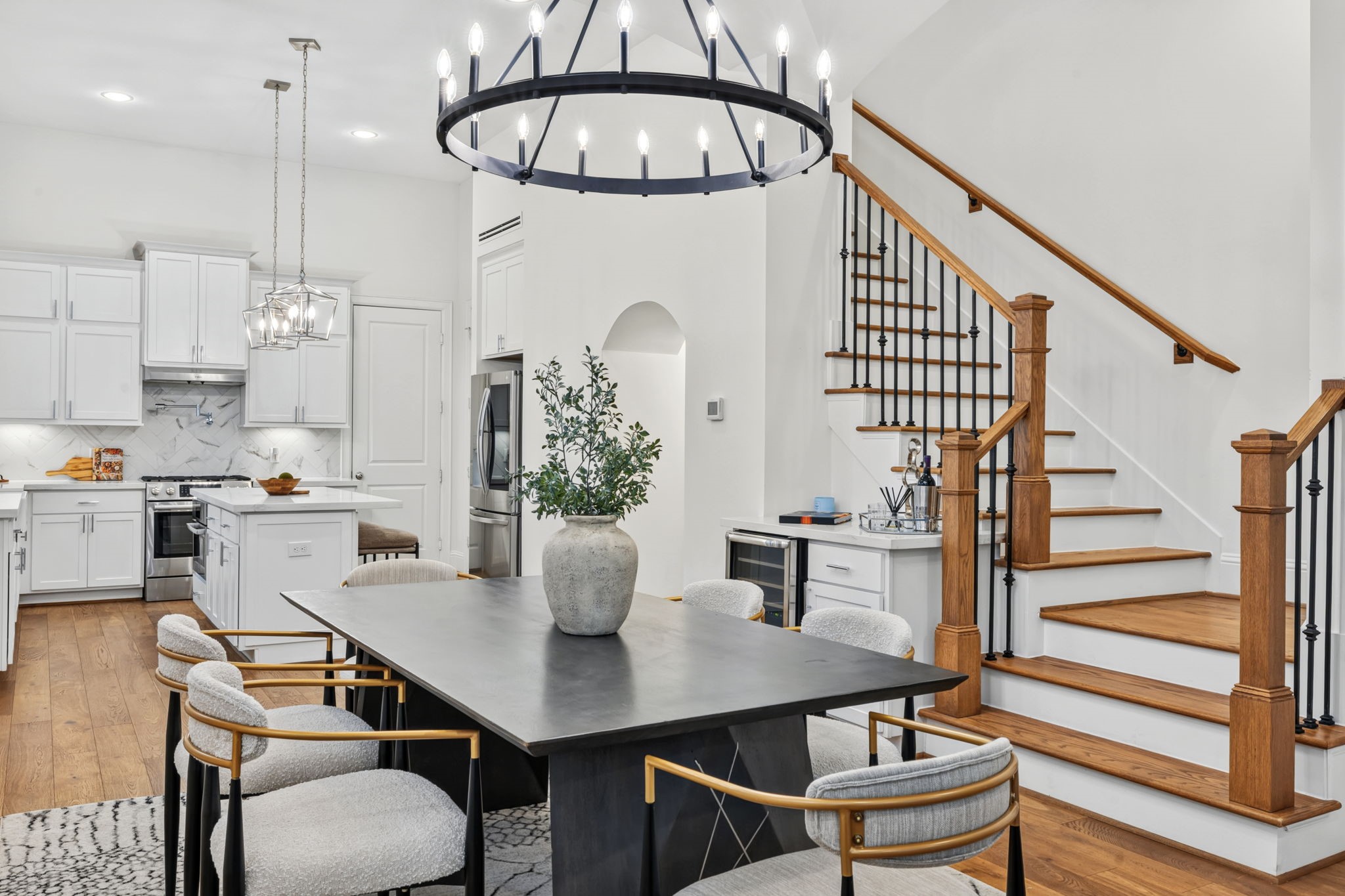 Dining room is anchored by a statement chandelier. Dining room is anchored by a statement chandelier.