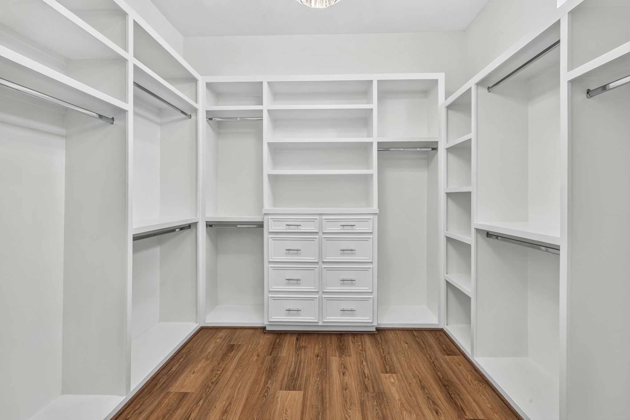 Step through classic French doors into a remarkably large primary walk-in closet designed with true luxury in mind. Anchored by a stunning statement chandelier.