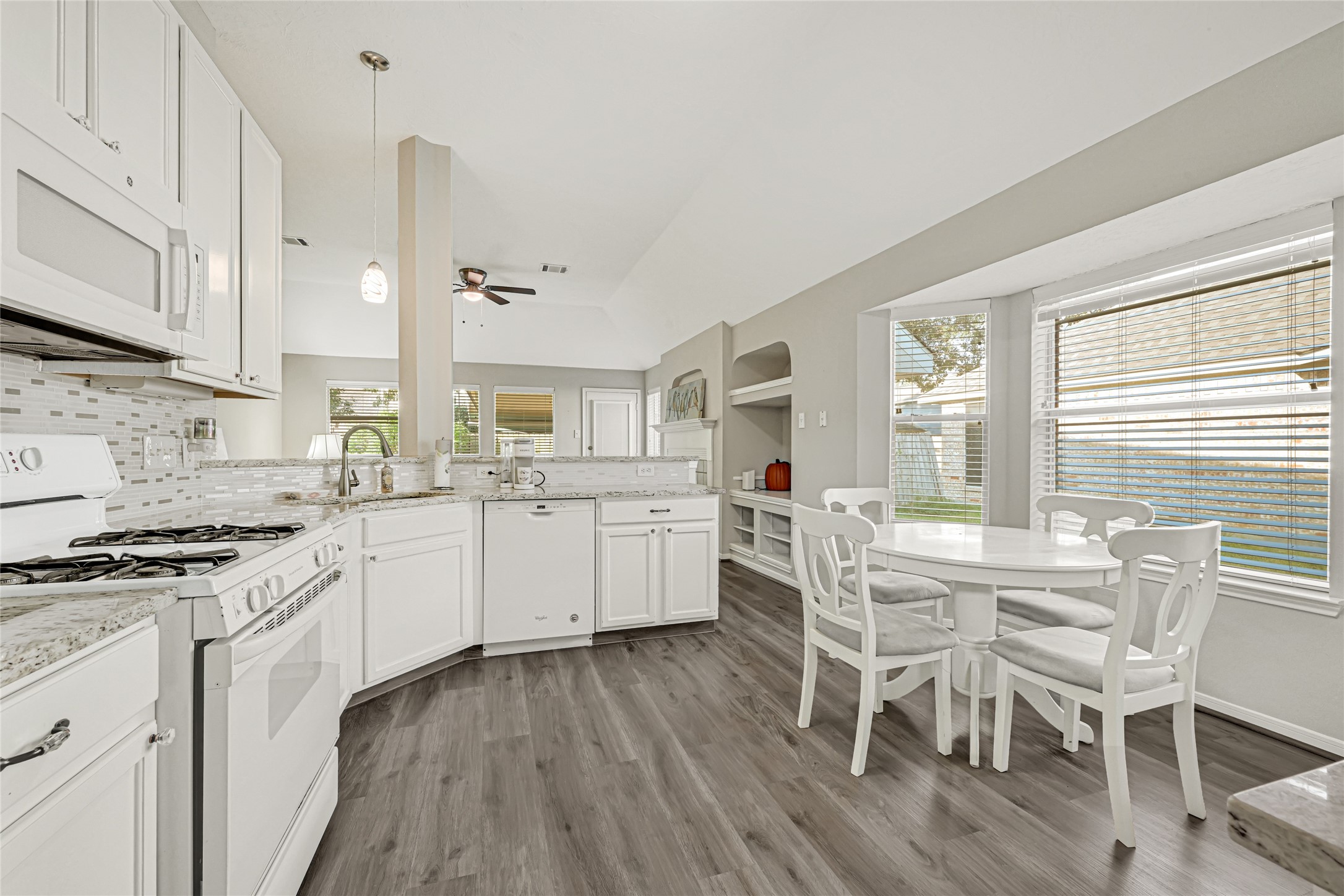 gas cooking and granite counters make this eat-in kitchen perfect for preparing meals