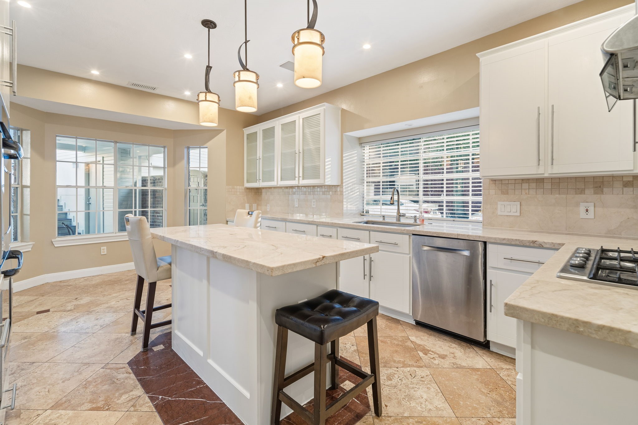Custom lighting fixtures over top the island as well as dimmable lighting throughout kitchen.