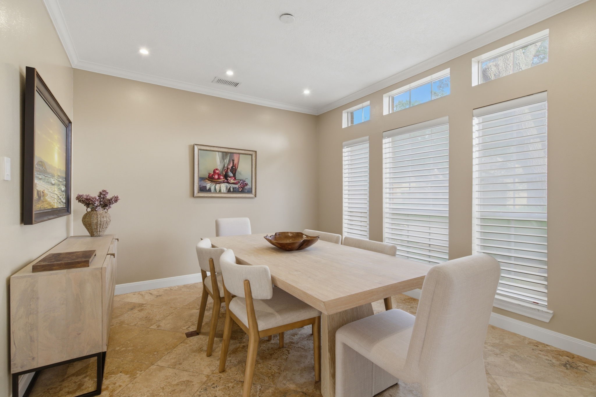 Formal dining designed with custom blinds that extend throughout the entire home along with customizable dimming lighting!