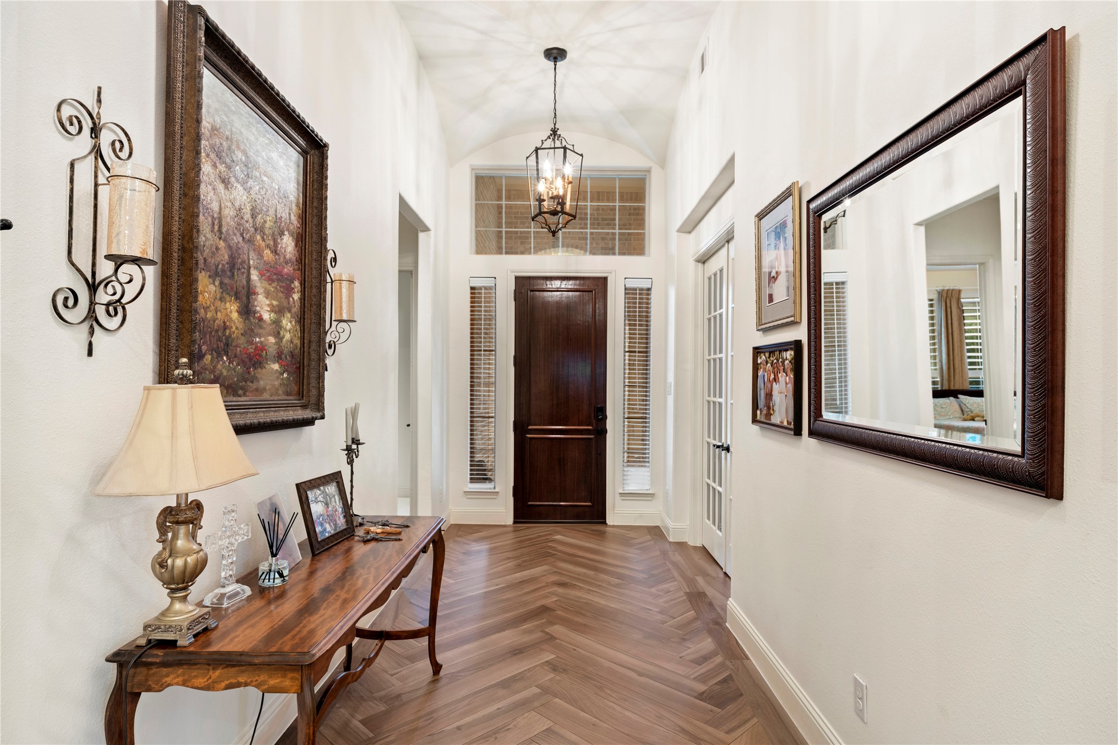 Step into elegance with an entryway featuring arched ceilings and exquisite Italian tile floors.