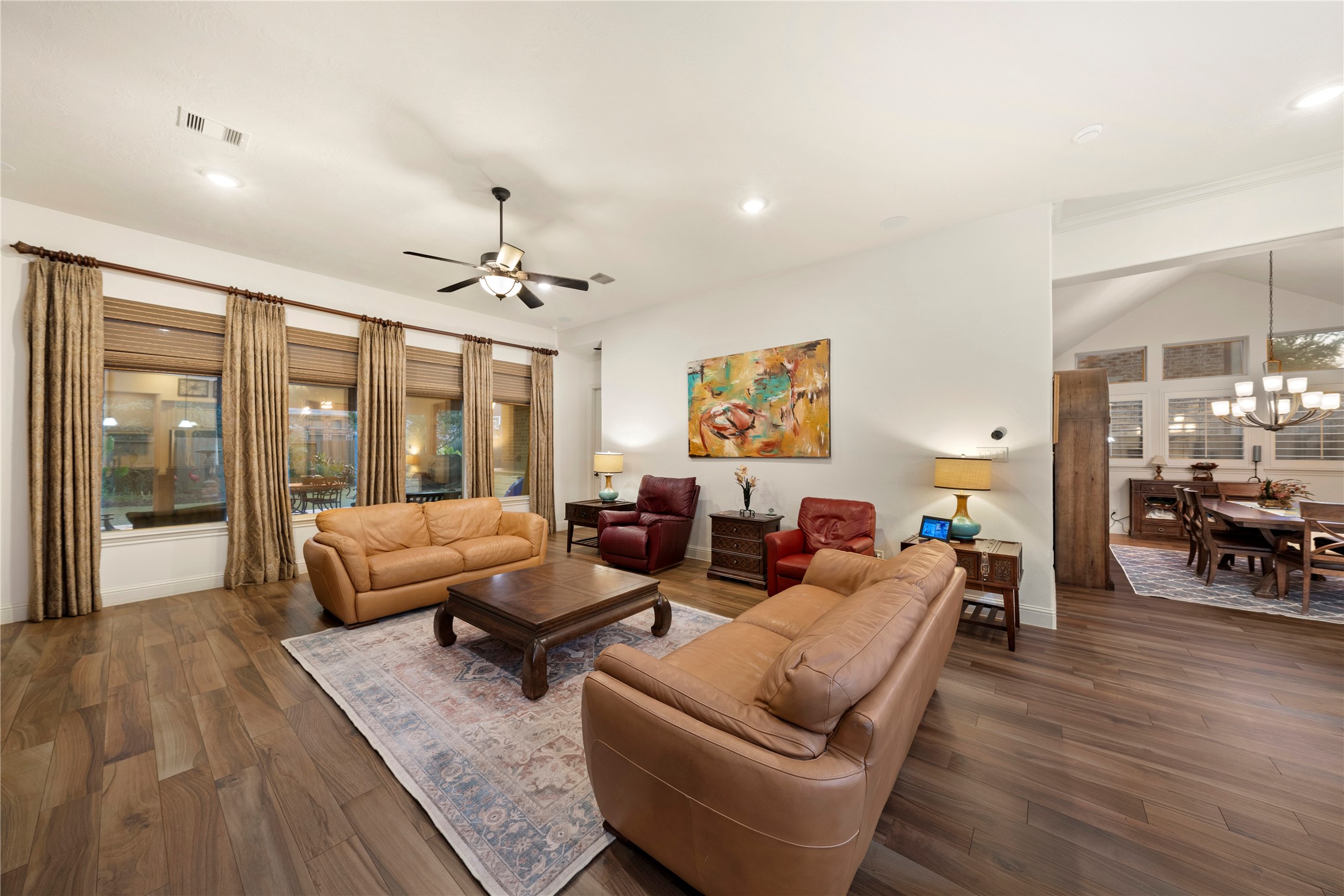 Spacious and inviting, this open-concept family and dining room boasts warm Italian tile flooring and abundant natural light, creating the perfect setting for gatherings and relaxation.