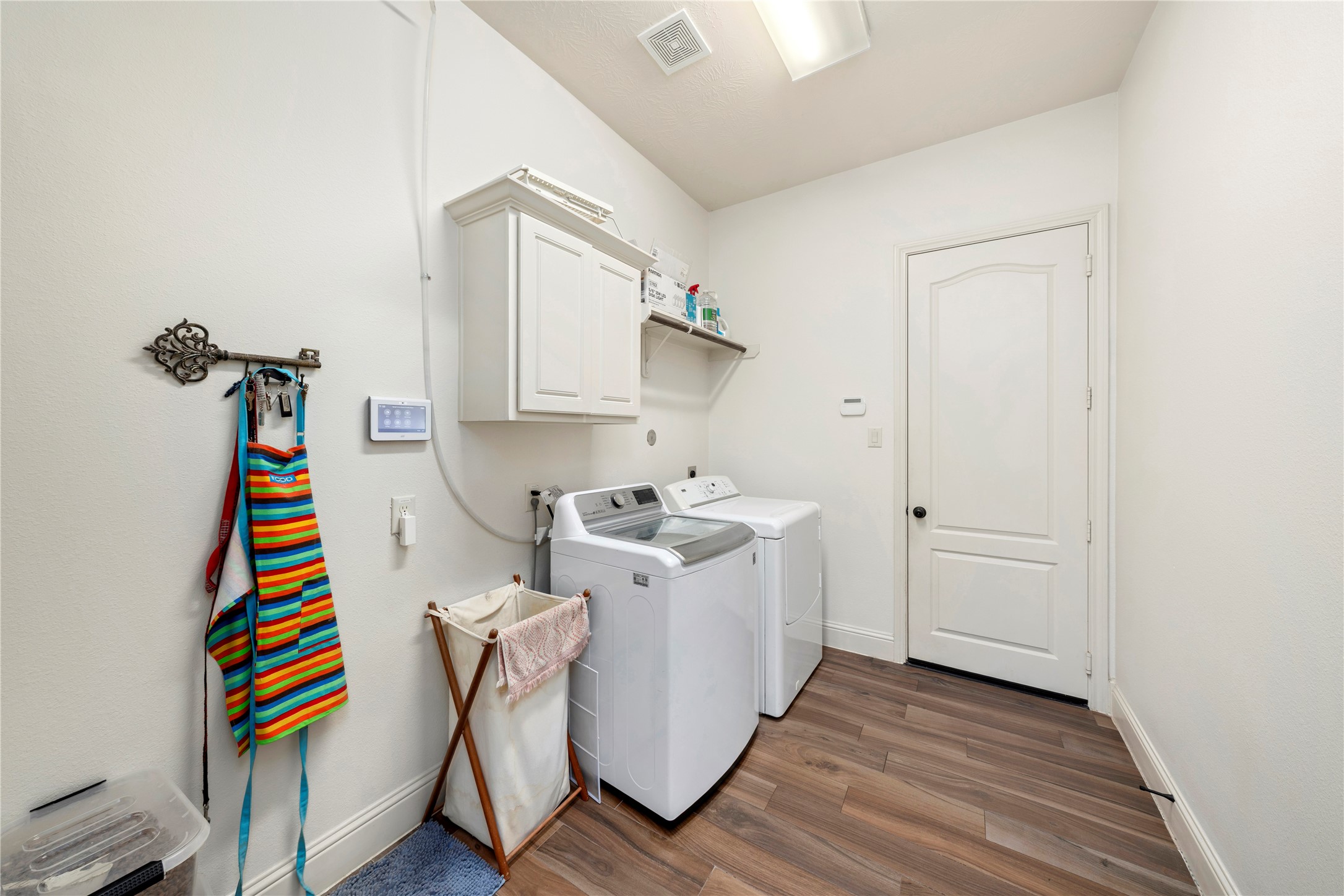 Conveniently positioned between the hidden pantry and the garage, the laundry room offers seamless access for efficient household flow.
