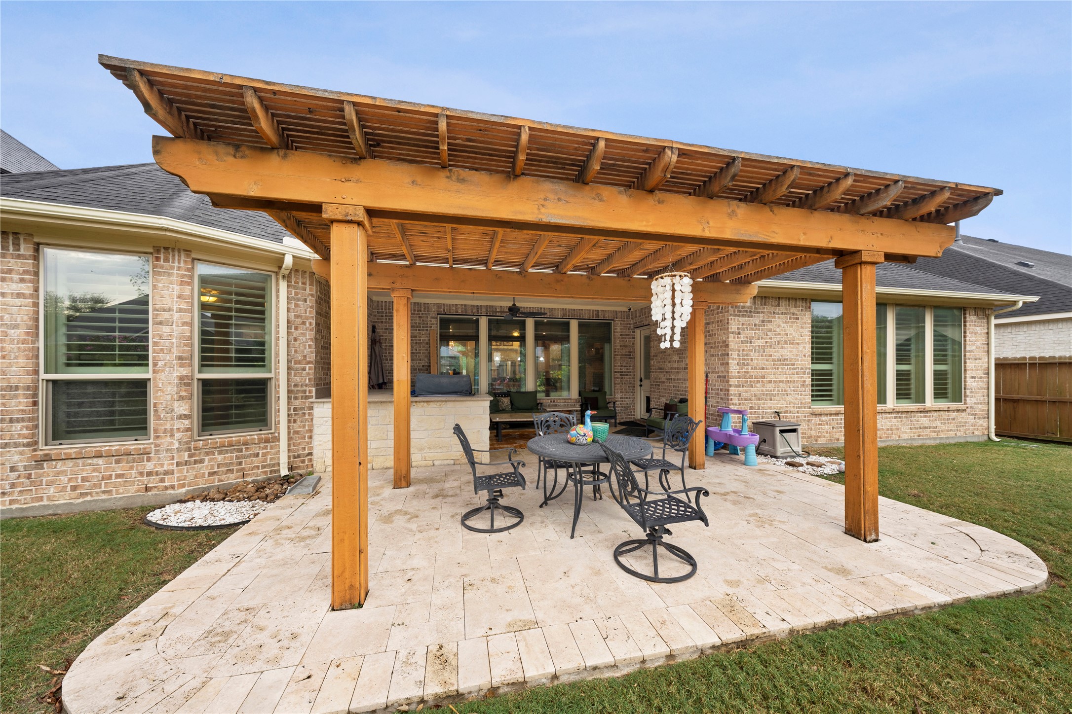 Enhance your outdoor living with this charming pergola, perfect for relaxing and entertaining on the spacious patio.