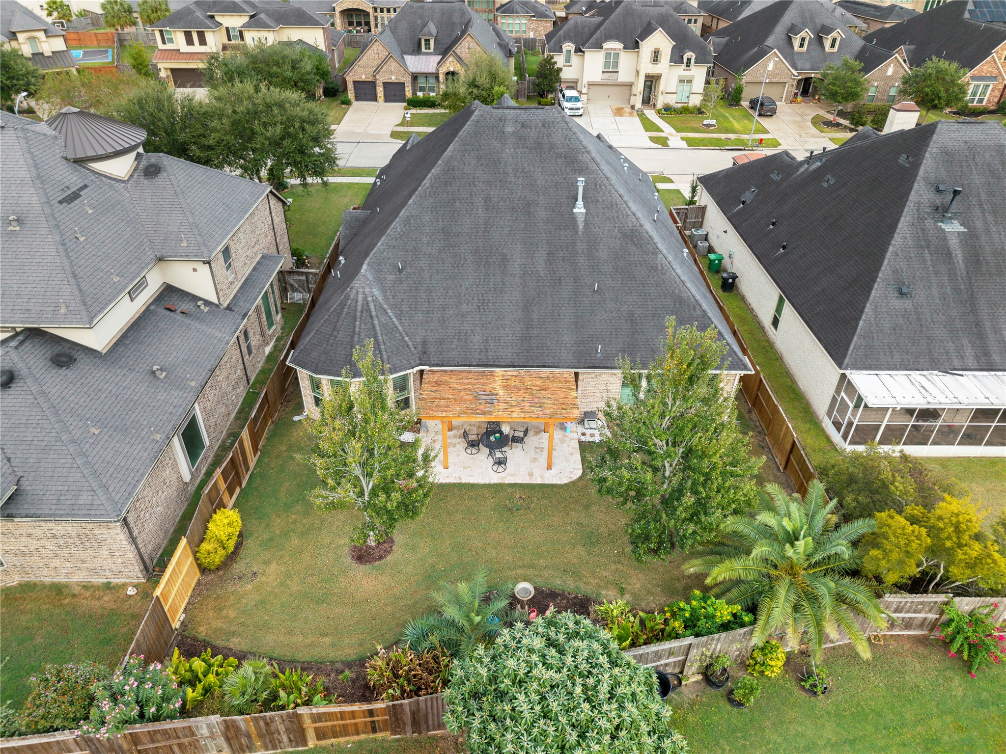 Charming suburban home featuring a spacious backyard with lush landscaping and a cozy patio area, perfect for outdoor gatherings. Charming suburban home featuring a spacious backyard with lush landscaping and a cozy patio area, perfect for outdoor gatherings.