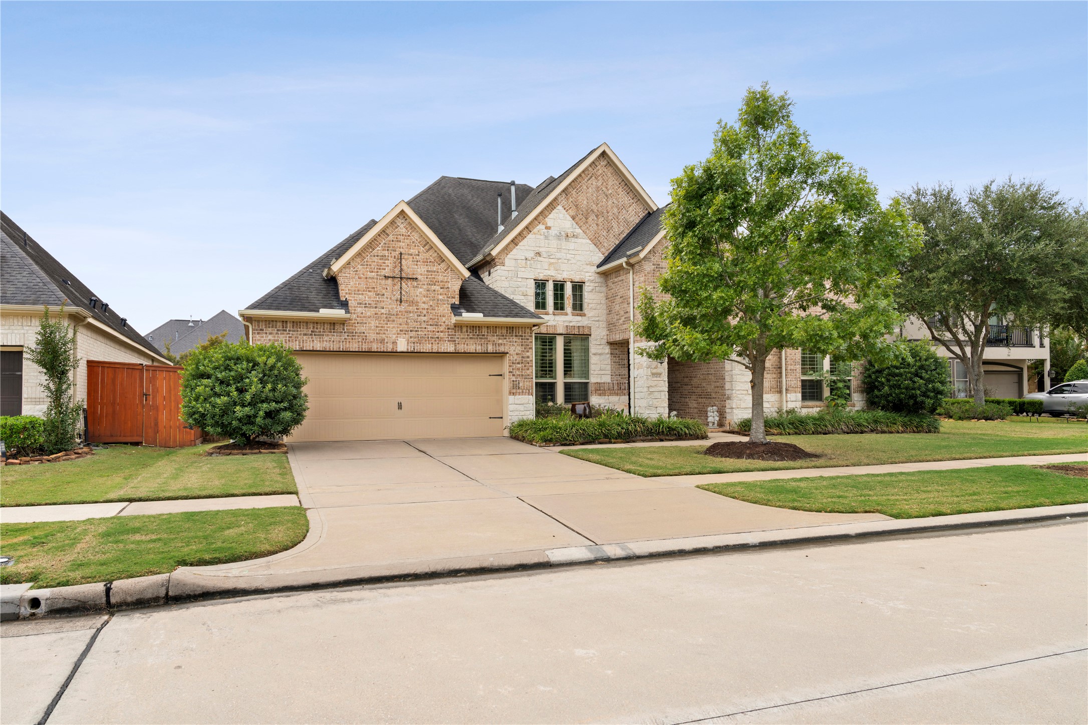 Expansive double-wide driveway leads to a spacious 3-car tandem garage with convenient built-in shelving, perfect for storage and organization. Expansive double-wide driveway leads to a spacious 3-car tandem garage with convenient built-in shelving, perfect for storage and organization.