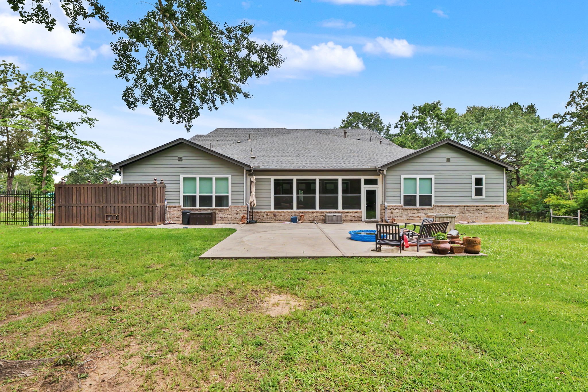 Relax and unwind on this spacious patio while taking in the serene views of the backyard and surrounding acreage.