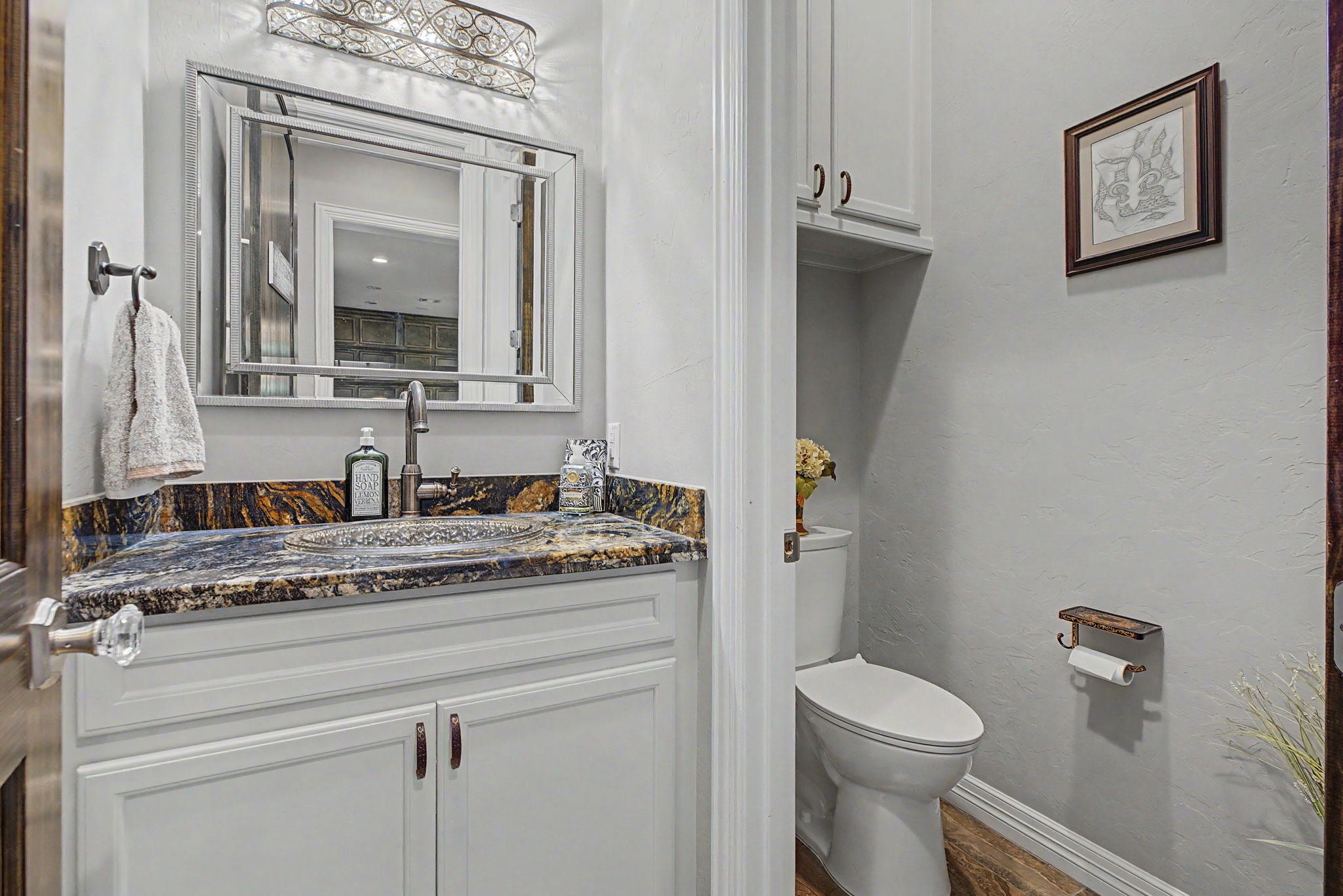 Convenient and stylish half bath located just steps from the main living areas.