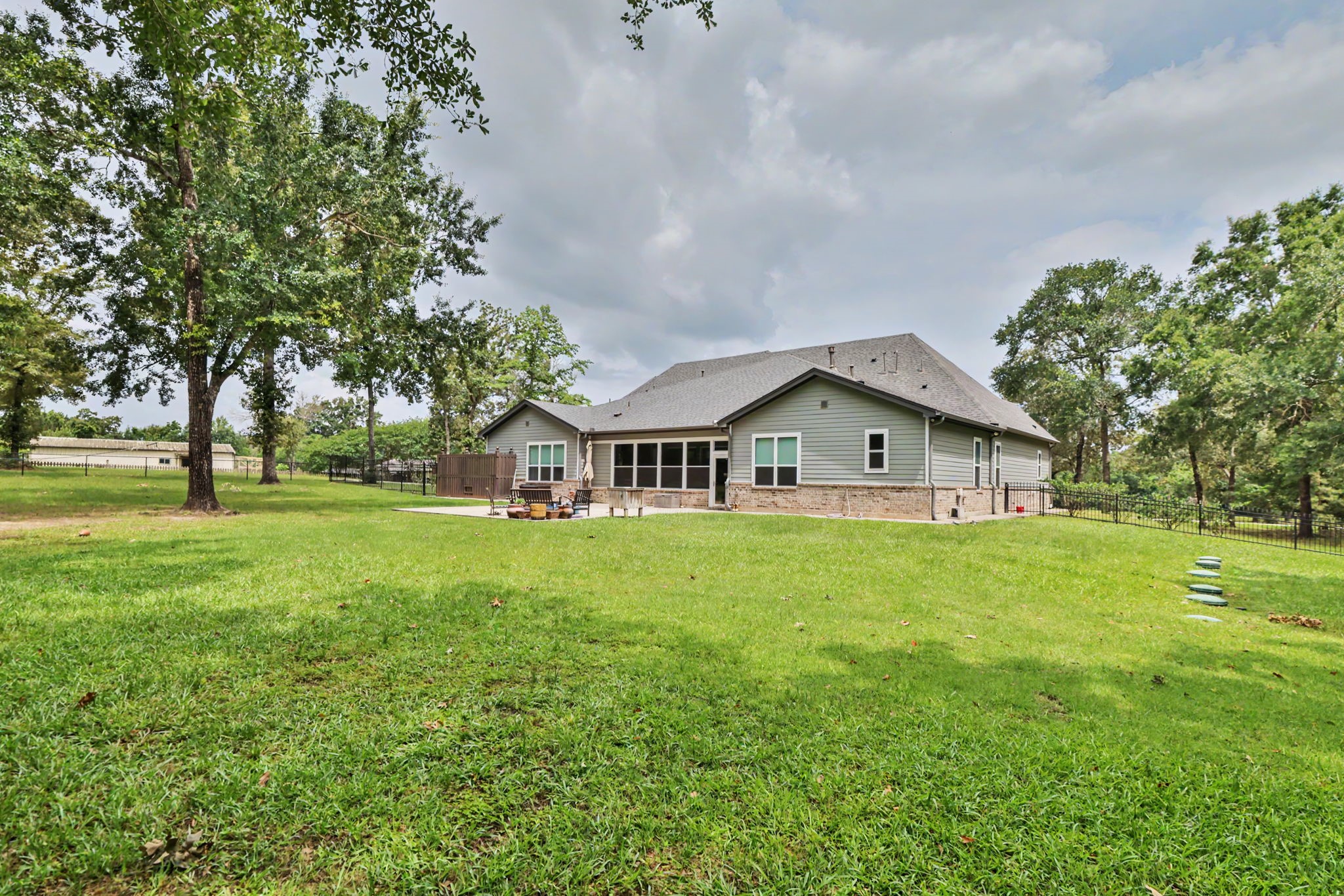 View from the rear of the property showcasing the spacious backyard and patio, perfect for relaxing or entertaining.