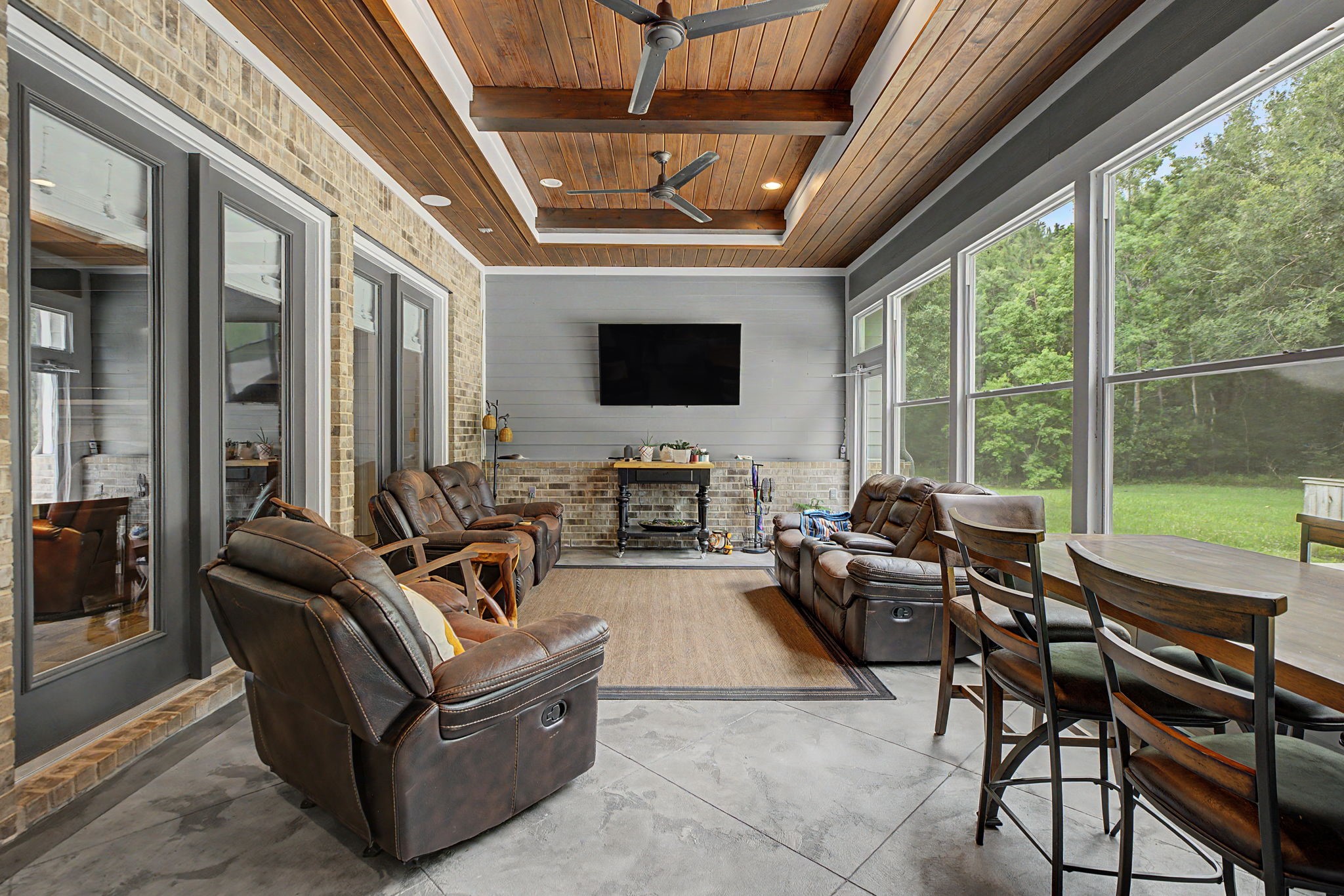 Another perspective of the sunroom, featuring picturesque views of the backyard and the property's serene setting.