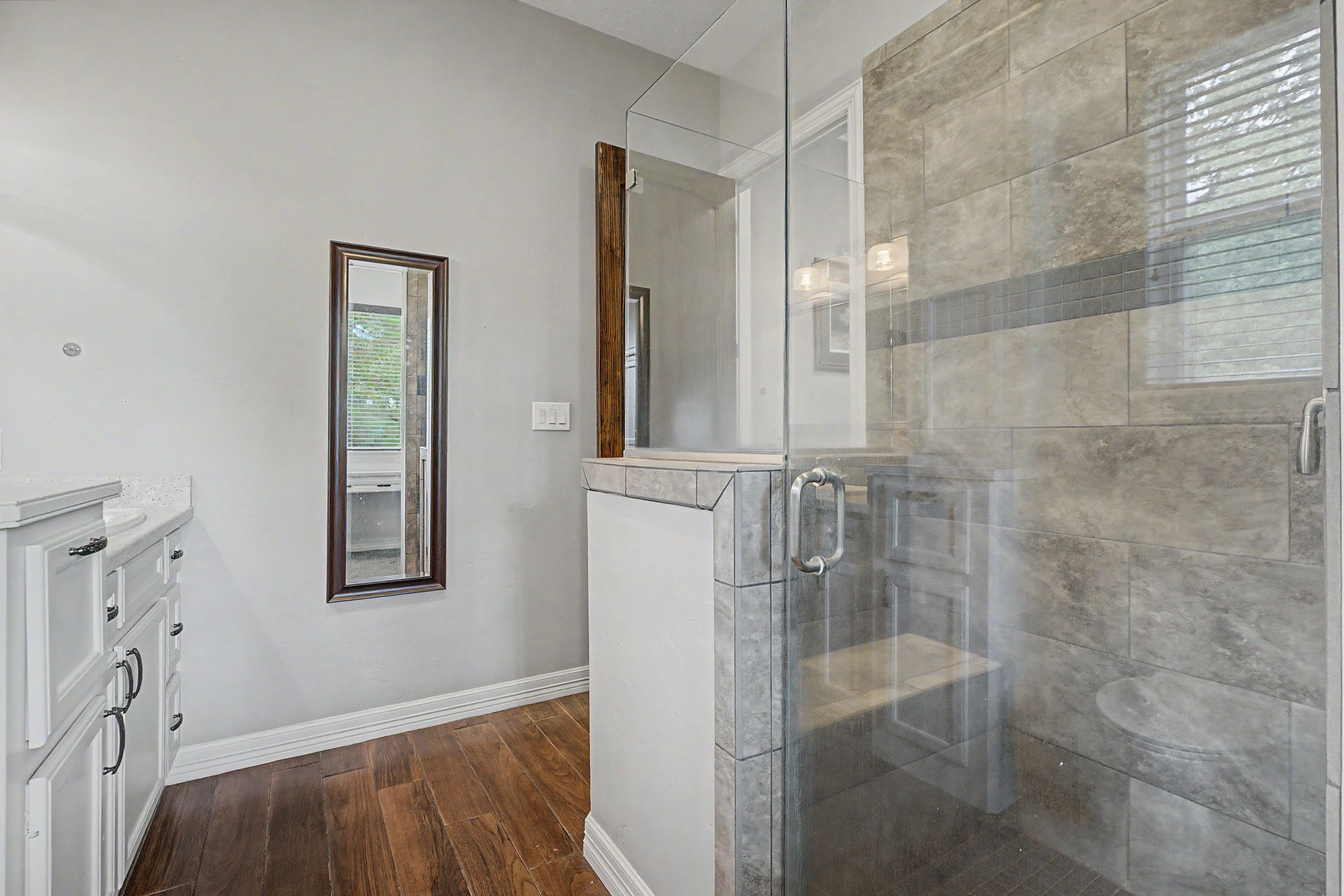 Enjoy the luxury of this oversized walk-in shower, complete with a built-in bench and beautiful finishes throughout.