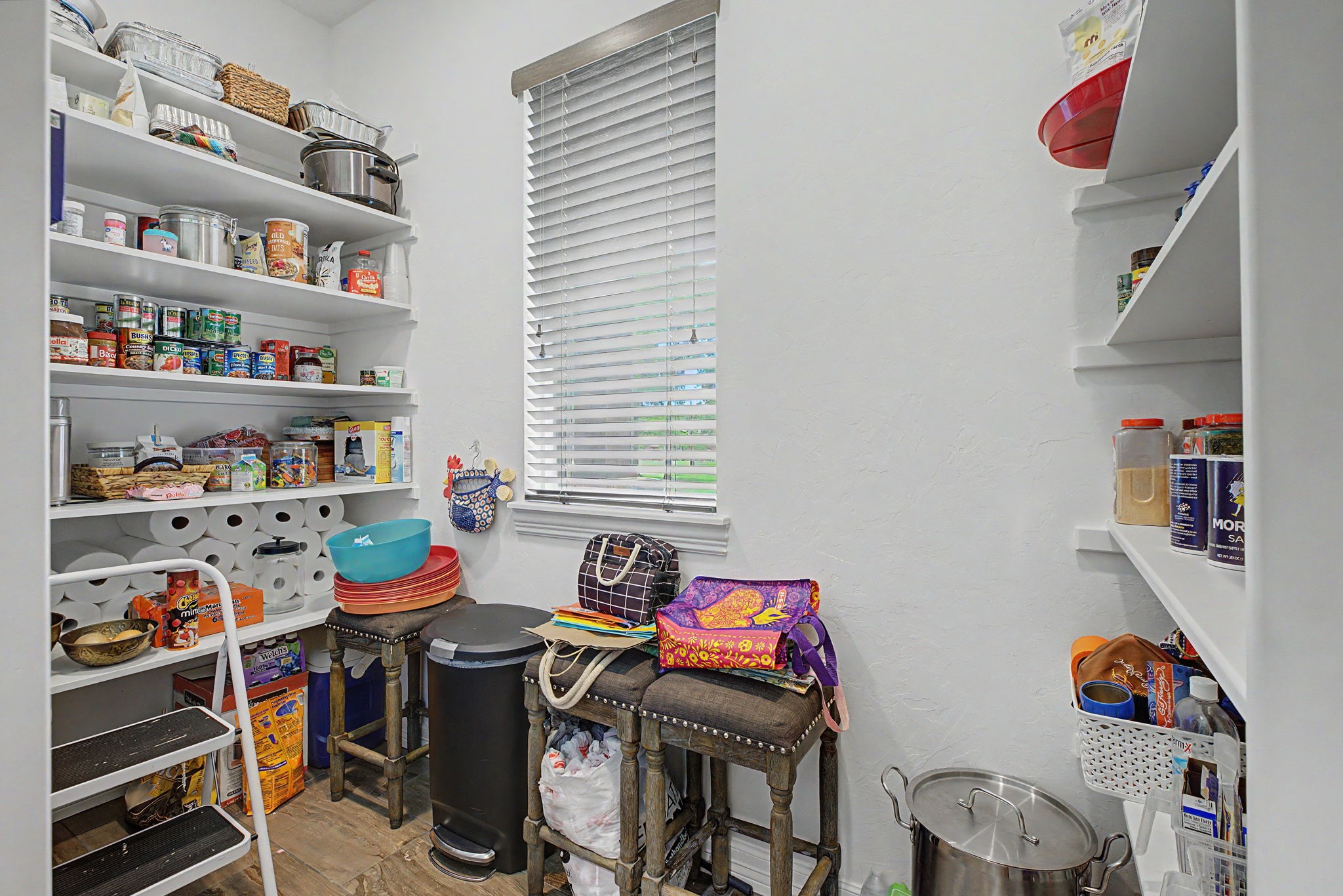 You'll love this massive walk-in pantry, featuring plenty of room for groceries, small appliances, and all your kitchen essentials.