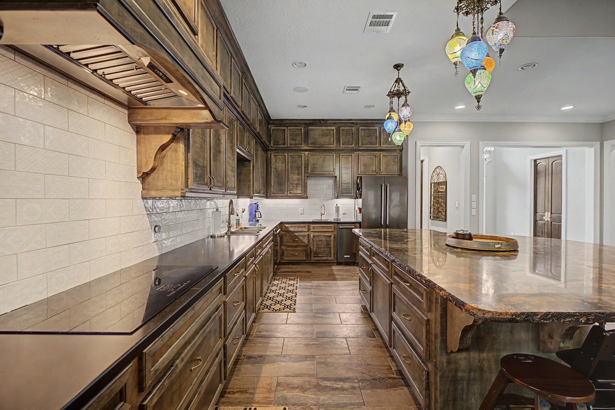 This view highlights the chef-inspired gourmet kitchen, designed with both functionality and style in mind.