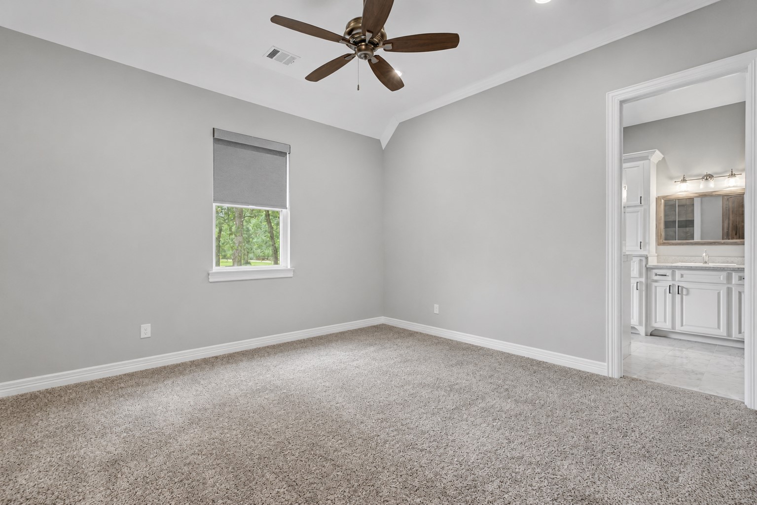 This generously sized Secondary Bedroom #1 includes its own ensuite bathroom and a large walk-in closet, making it ideal for guests or family members.