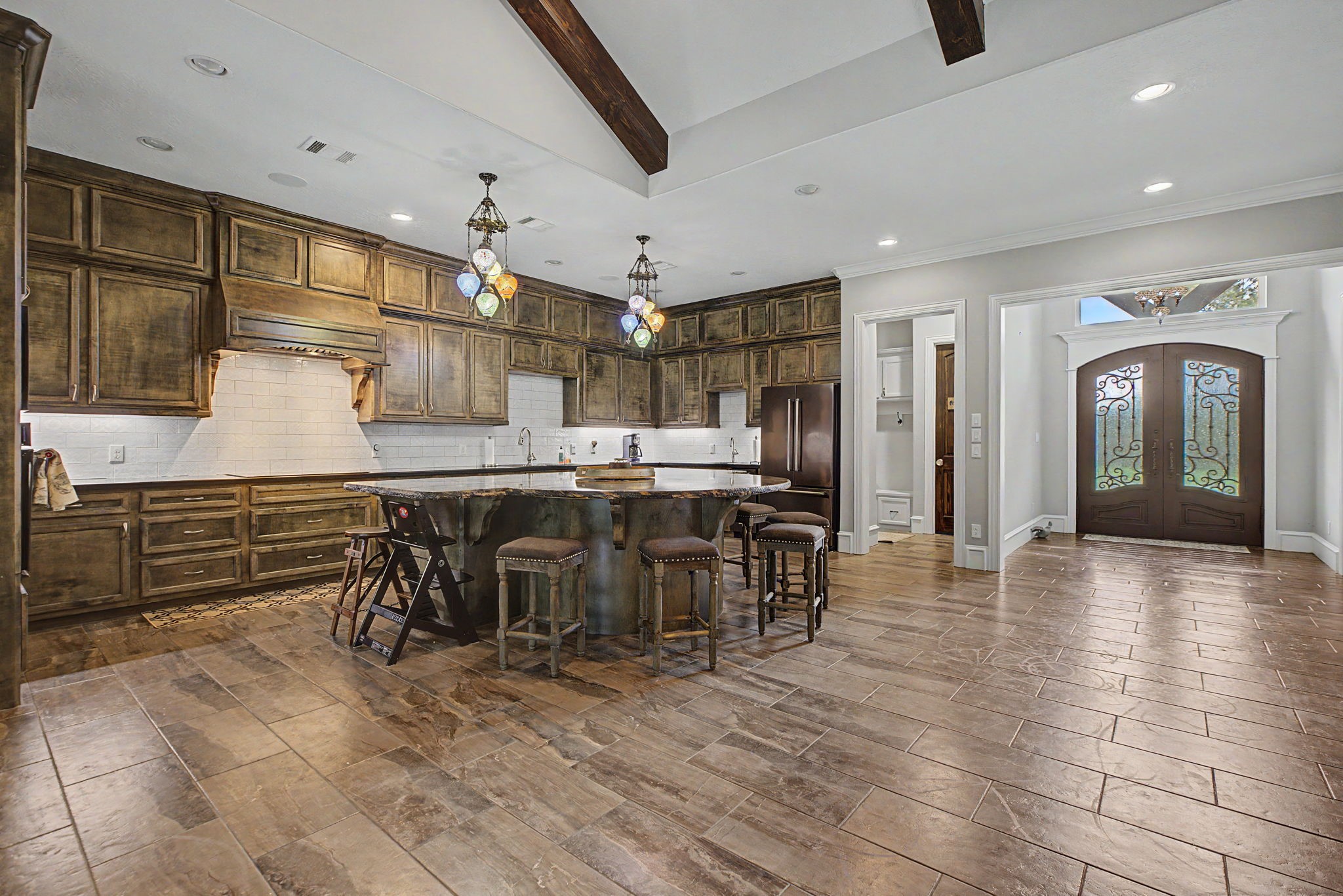 This view of the kitchen showcases the custom cabinetry and abundant storage space, offering both beauty and functionality.