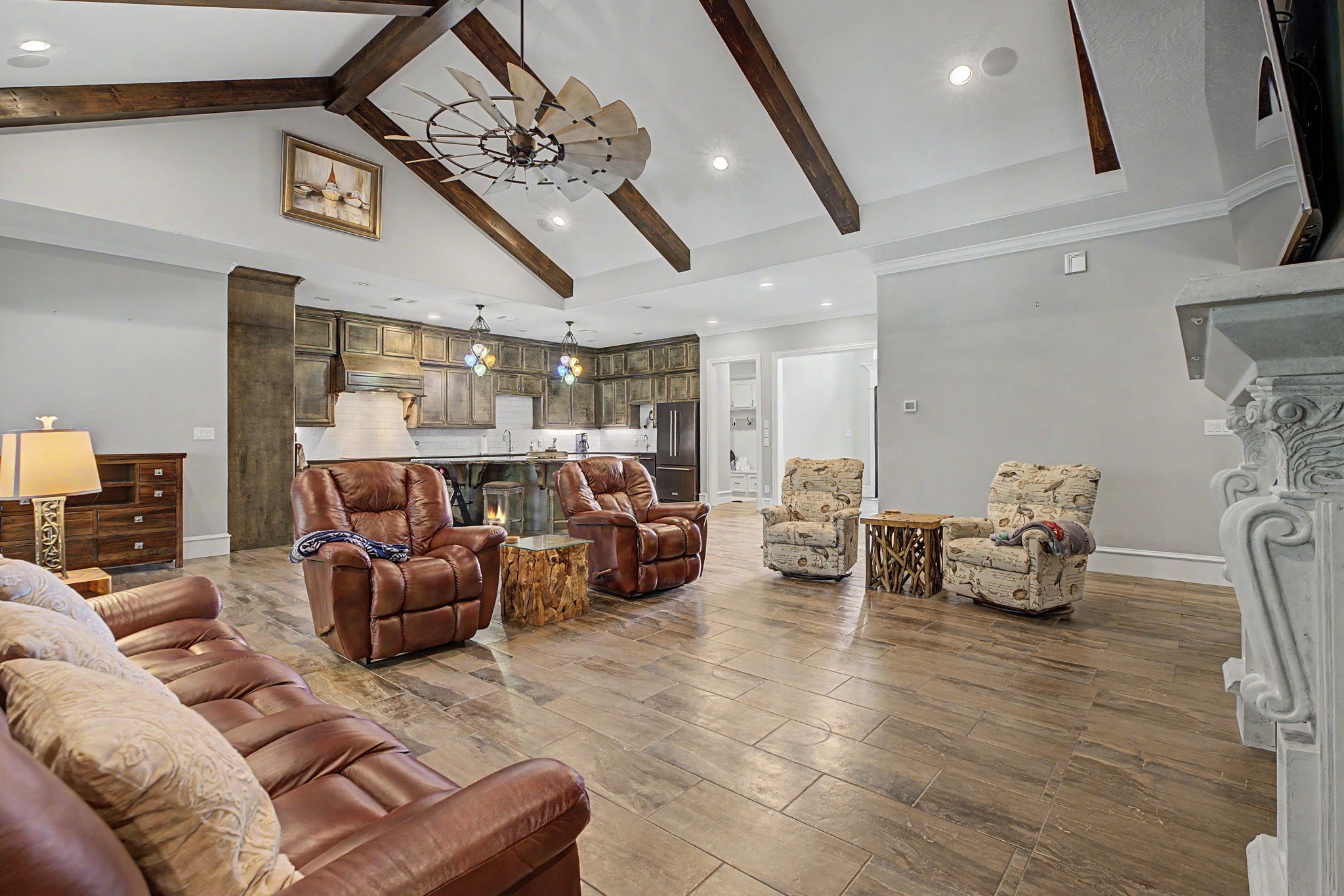 View from the living room into the kitchen, showcasing the stunning vaulted ceilings and open-concept design. View from the living room into the kitchen, showcasing the stunning vaulted ceilings and open-concept design.