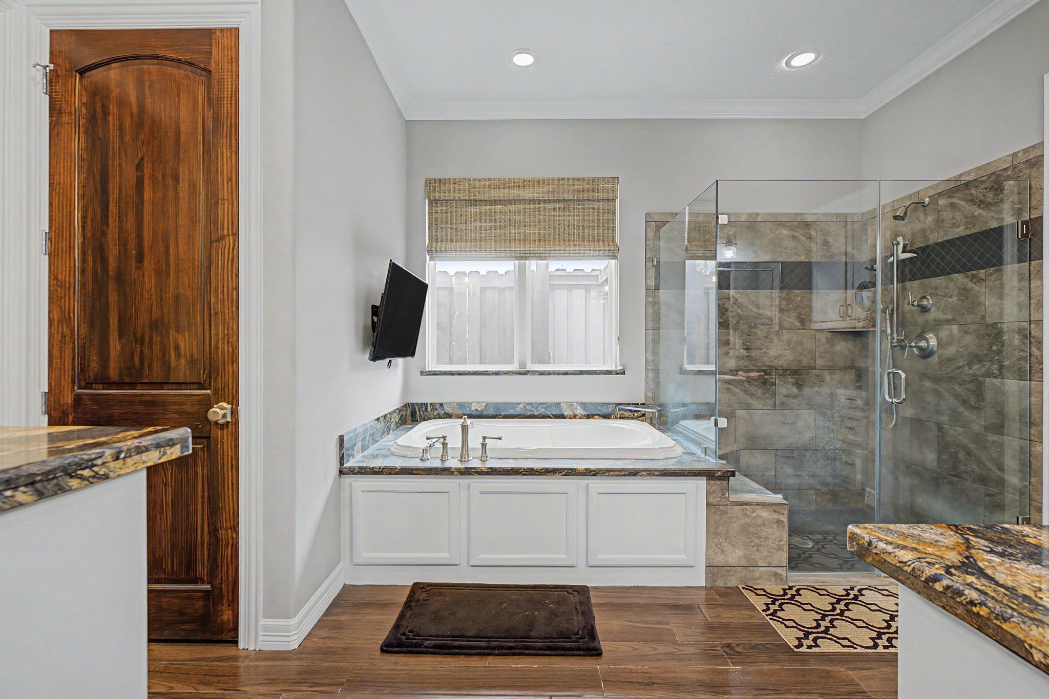 Imagine soaking in this luxurious garden tub while catching up on your favorite TV series.