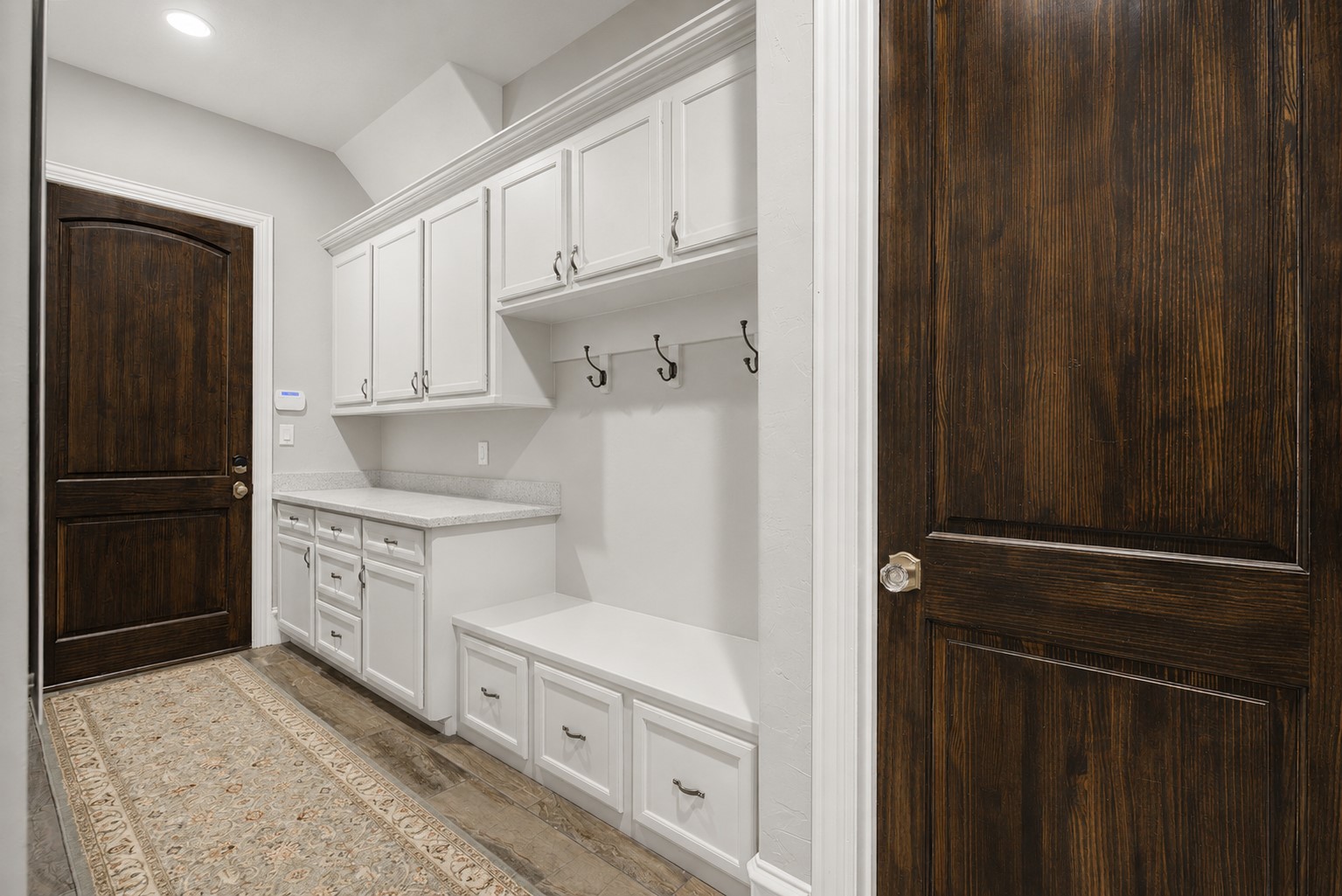 Designed with organization in mind, this spacious mud room provides ample storage and serves as the perfect transition from the garage into the home.