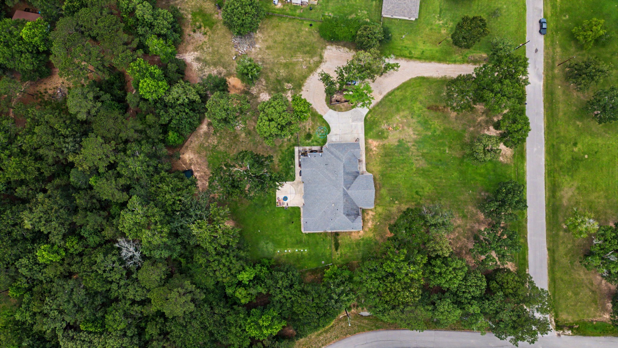 Aerial view showcasing 5 acres of space, privacy, and endless possibilities.