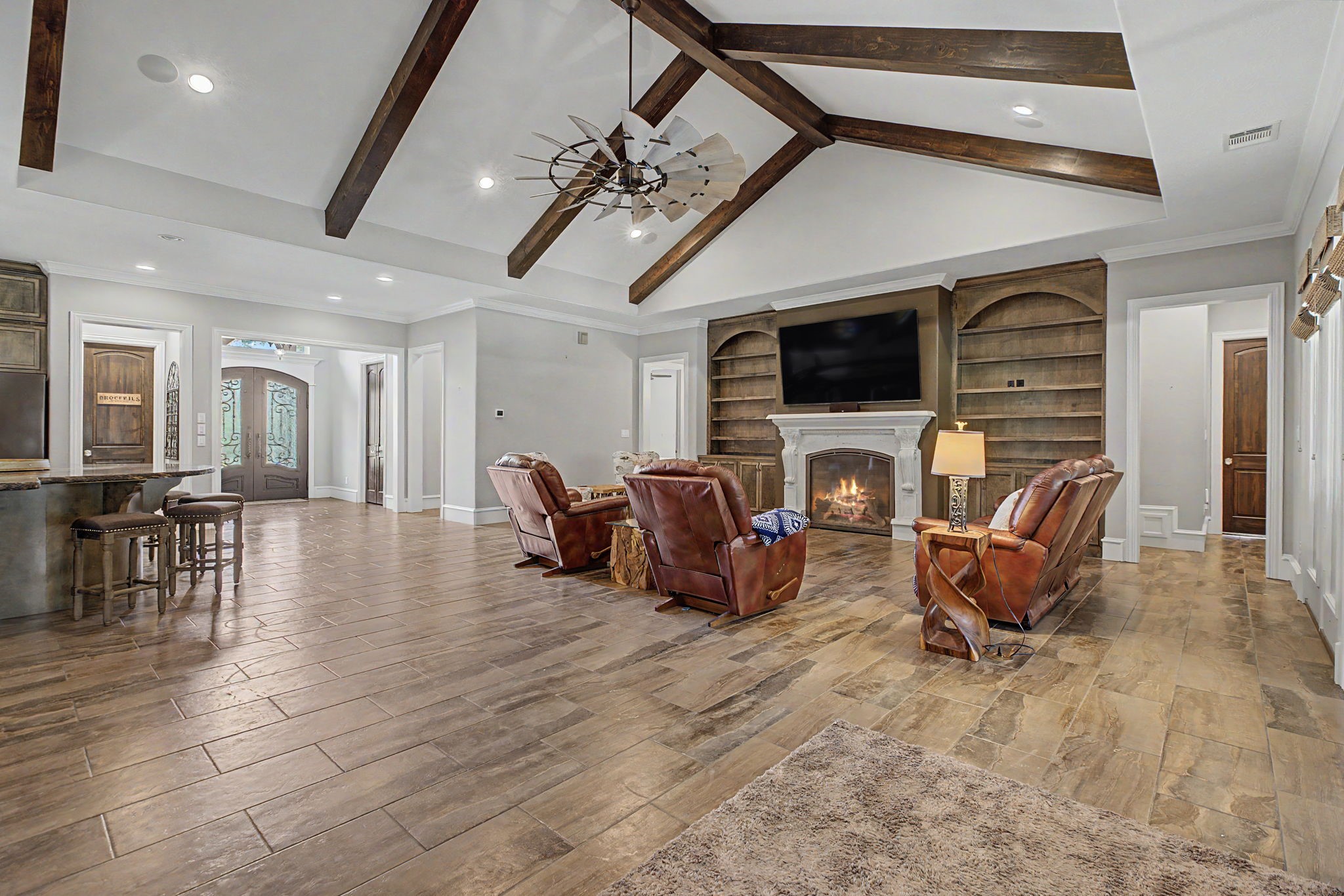 This view from the living room captures the connection between the kitchen and foyer, creating a bright and welcoming living space. This view from the living room captures the connection between the kitchen and foyer, creating a bright and welcoming living space.