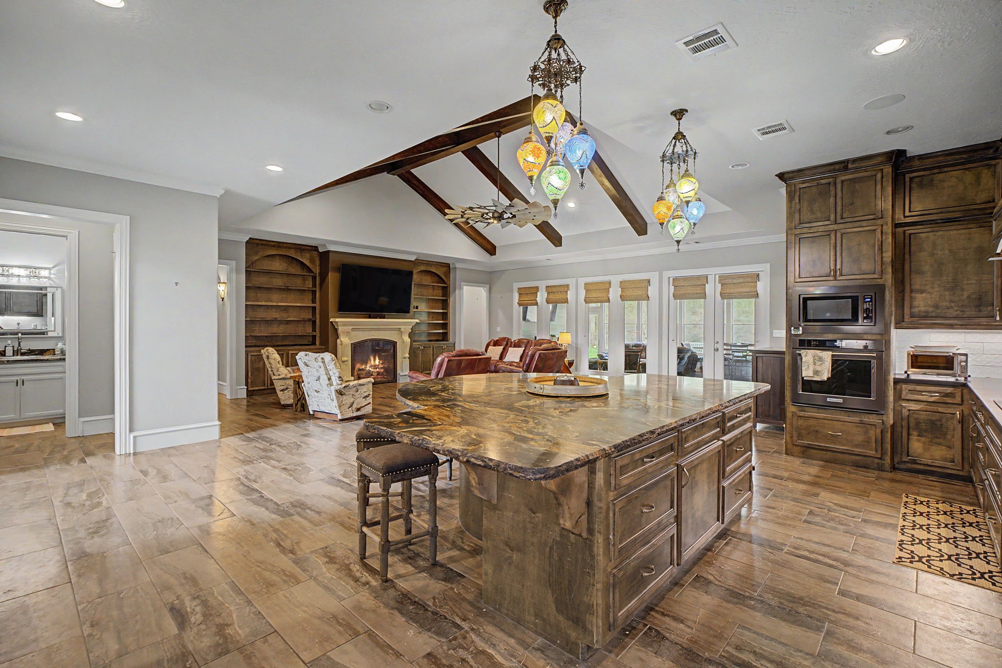 Take a look at the oversized kitchen island, featuring gorgeous granite countertops and stunning imported light fixtures that add a touch of elegance.