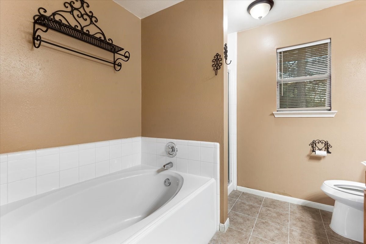 Soaking tub and separate shower.