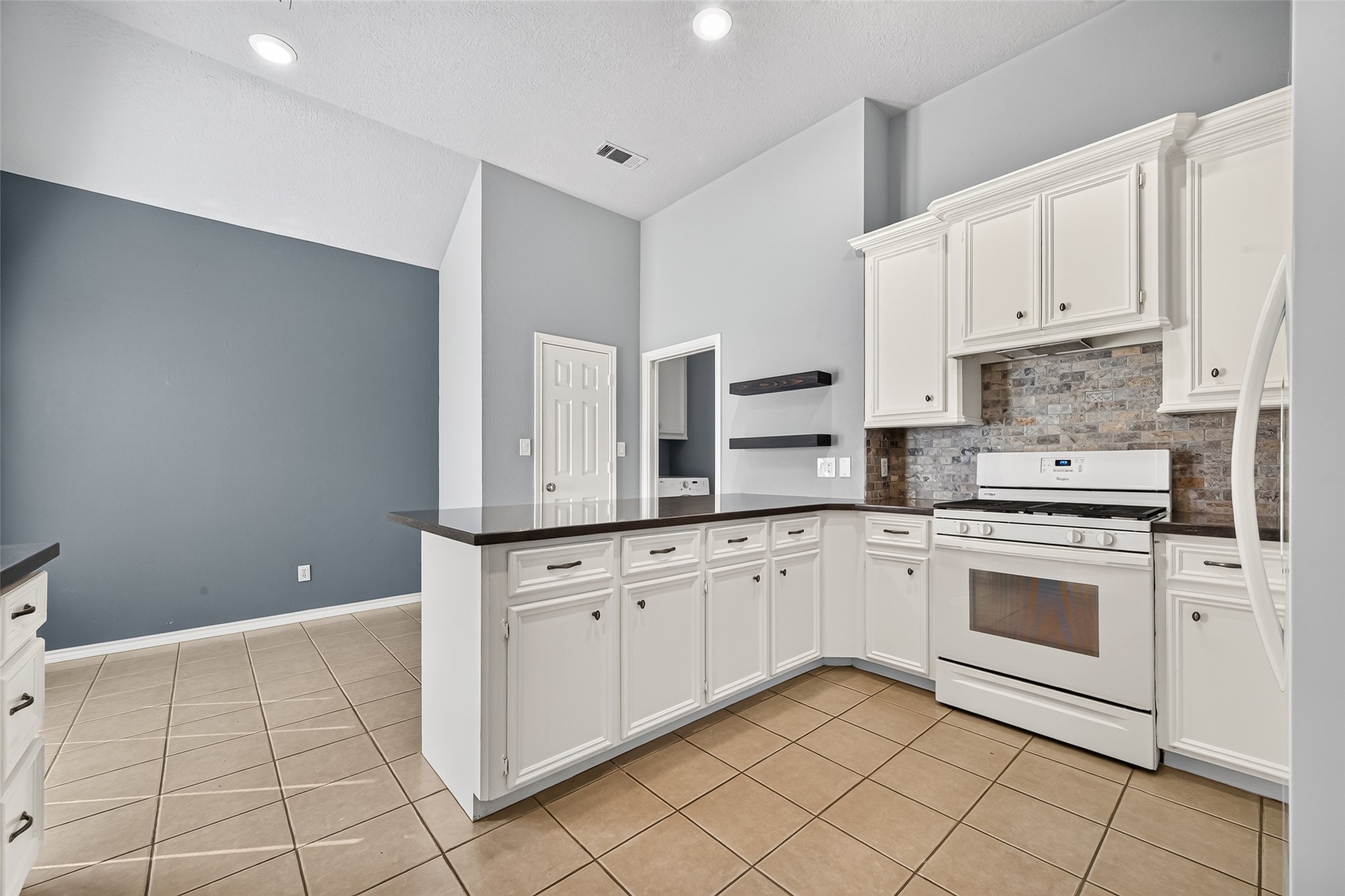 Light and bright kitchen with plenty of cabinets for storage