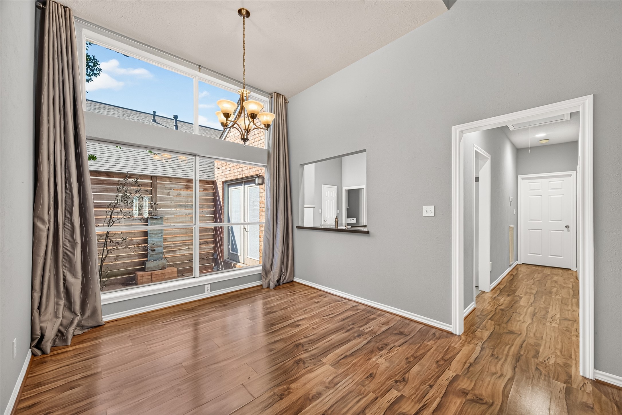 Formal dining space and hallway to kitchen and additional bedrooms