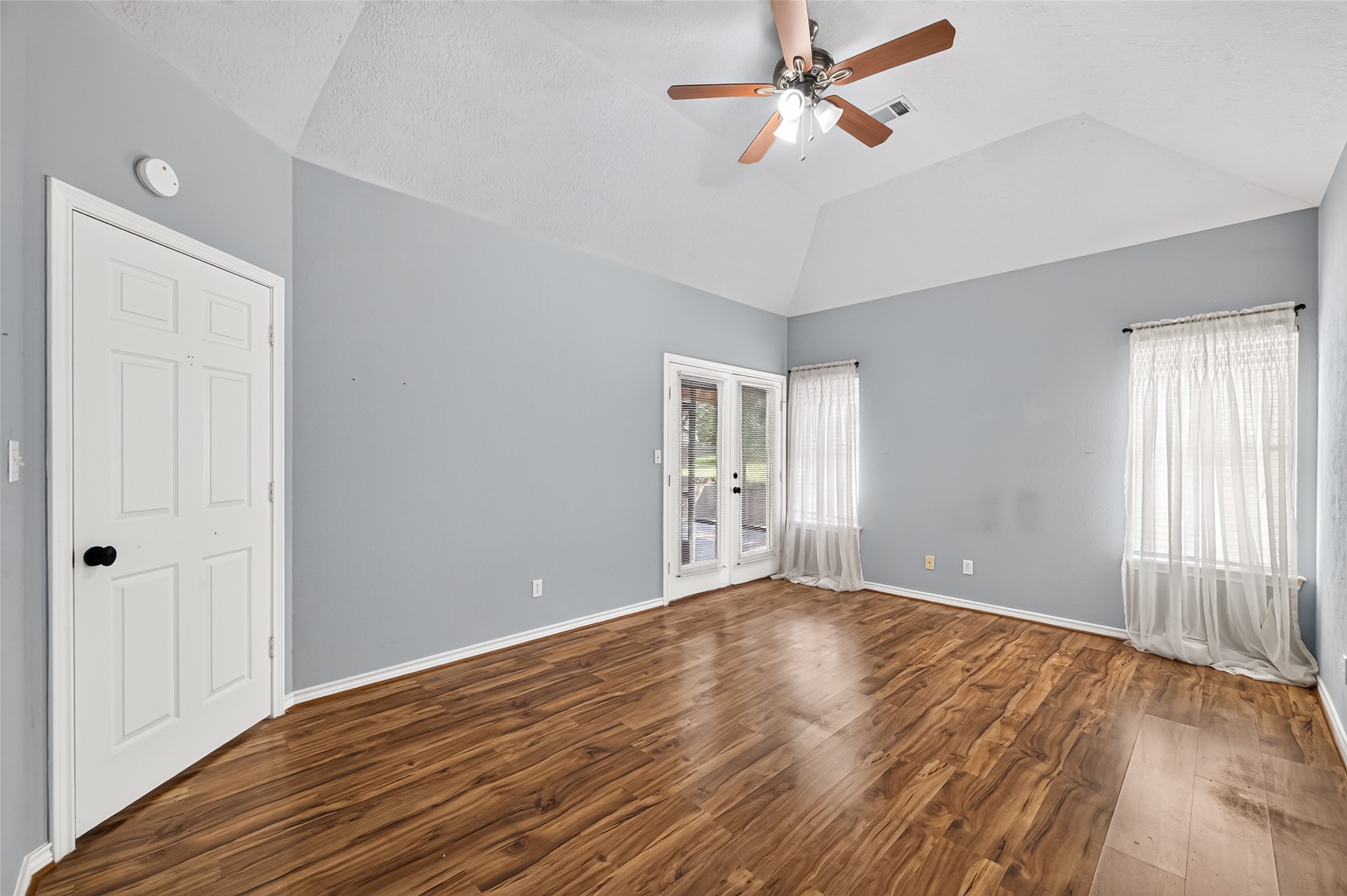 Primary bedroom with entry onto screened porch
