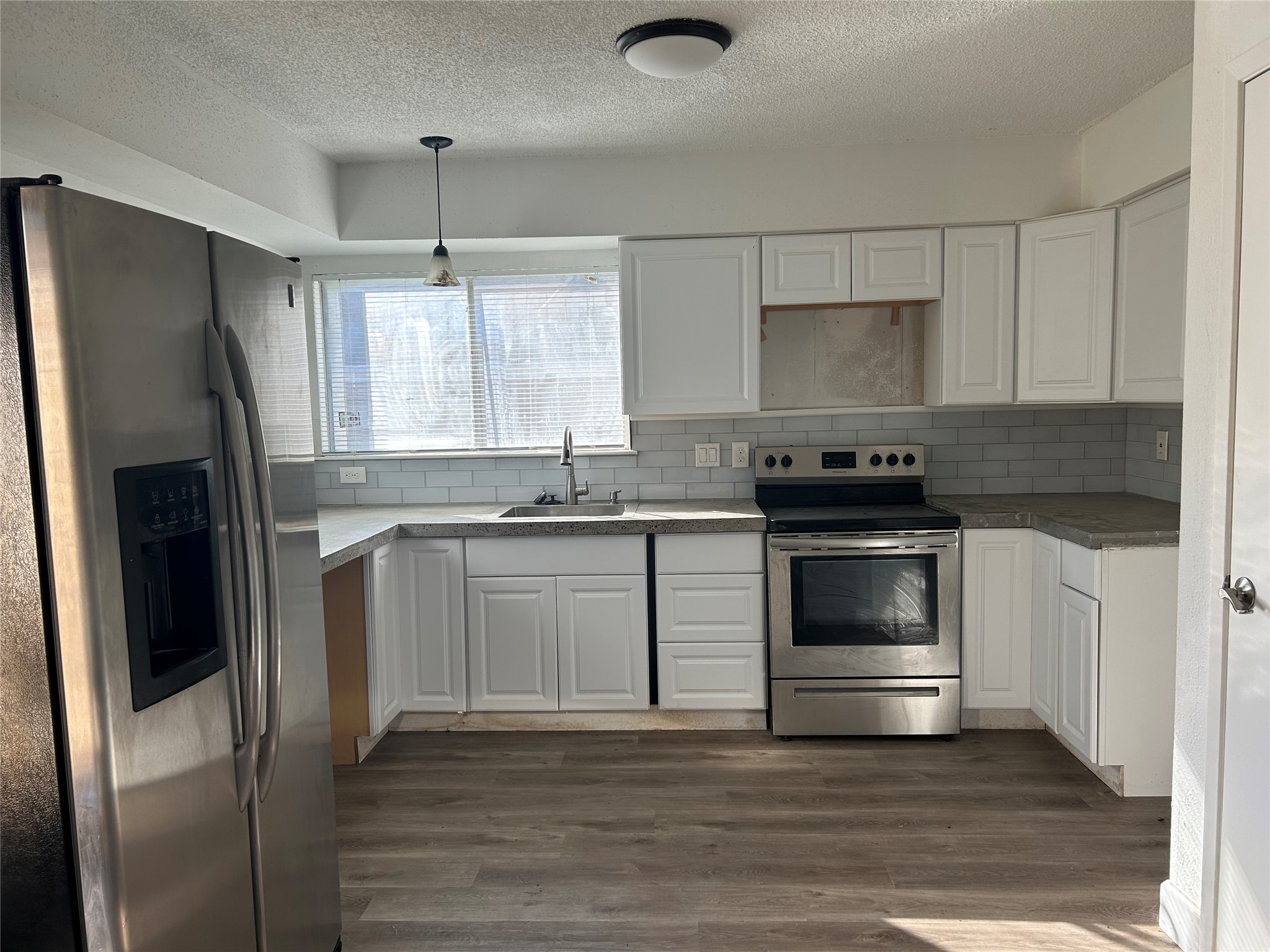 Beautiful kitchen with abundant cabinets and window by the sink.
