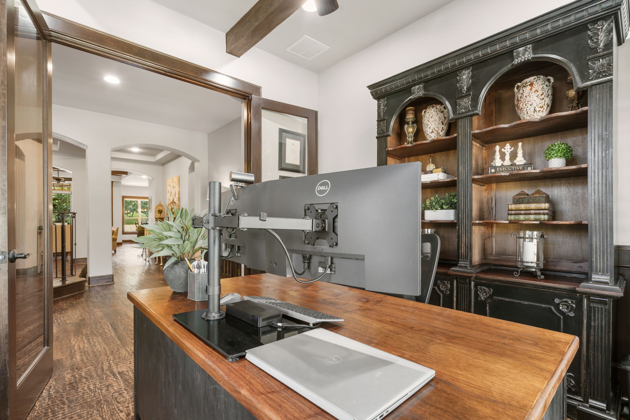Rich wood wainscoting and beautiful architectural details create a sophisticated setting for working from home.