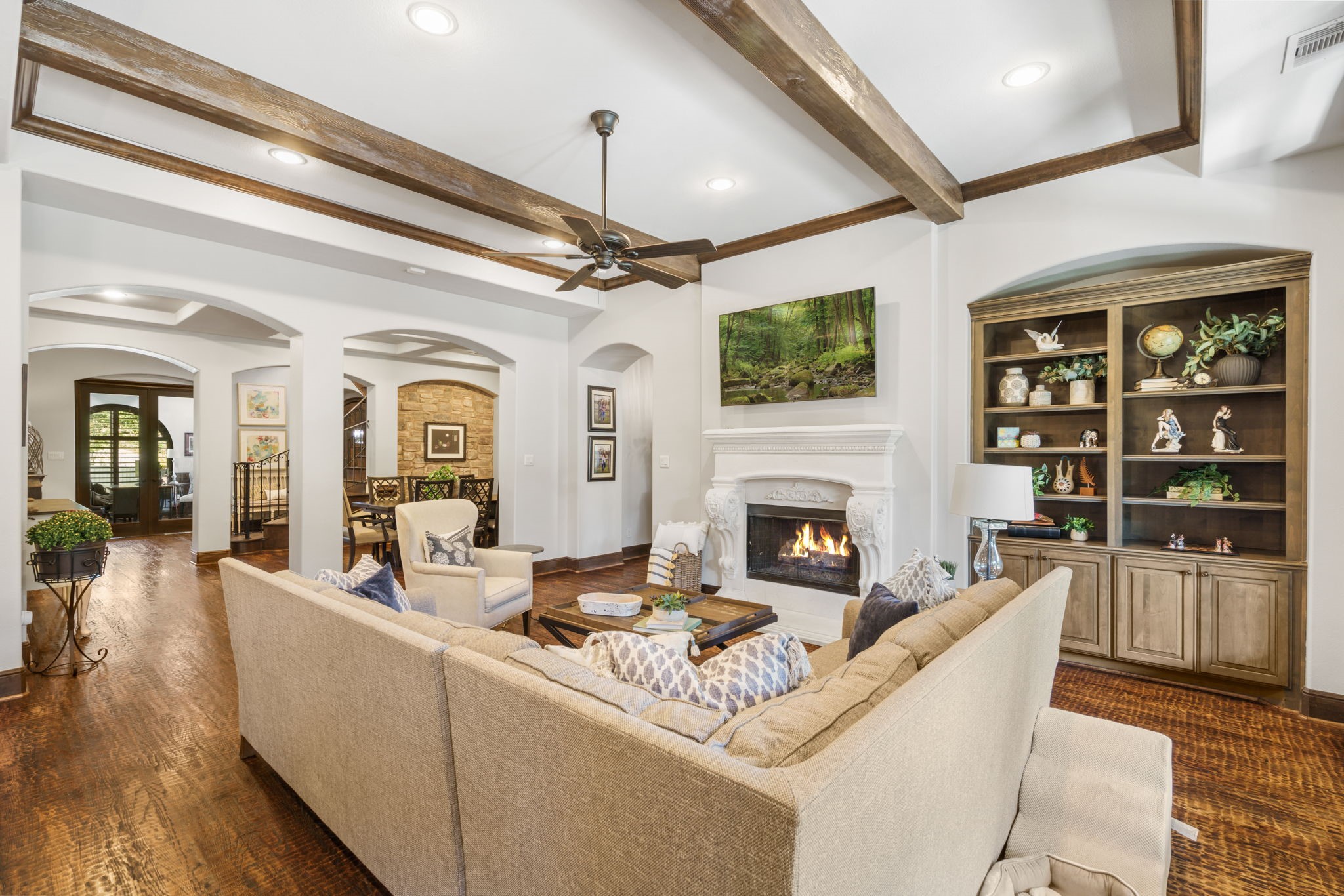 Beautifully detailed fireplace with an ornate mantel creates an inviting focal point, complemented by custom built-in cabinetry.