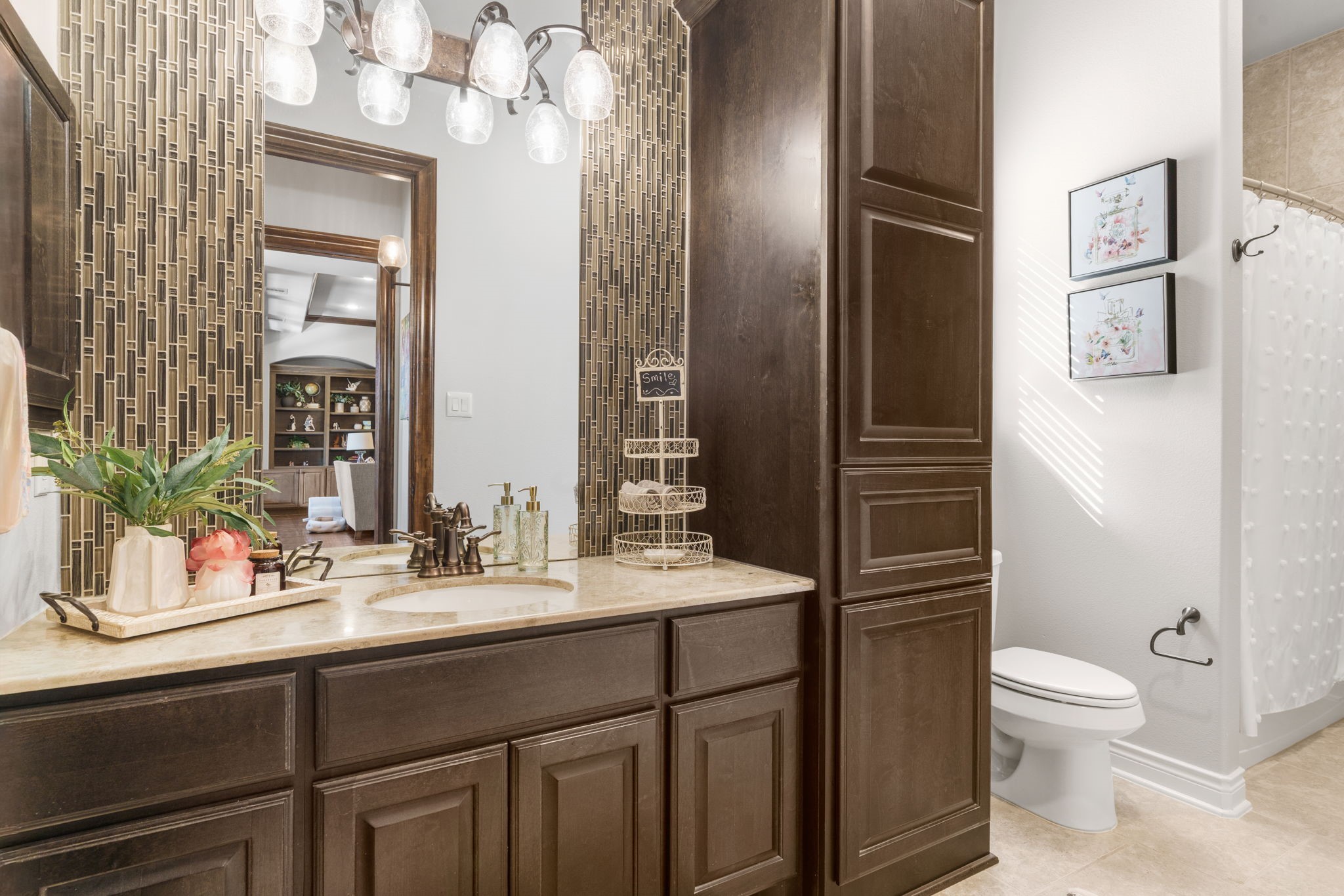 Beautifully appointed full bathroom featuring granite countertops, rich wood cabinetry, decorative and tile accents.
