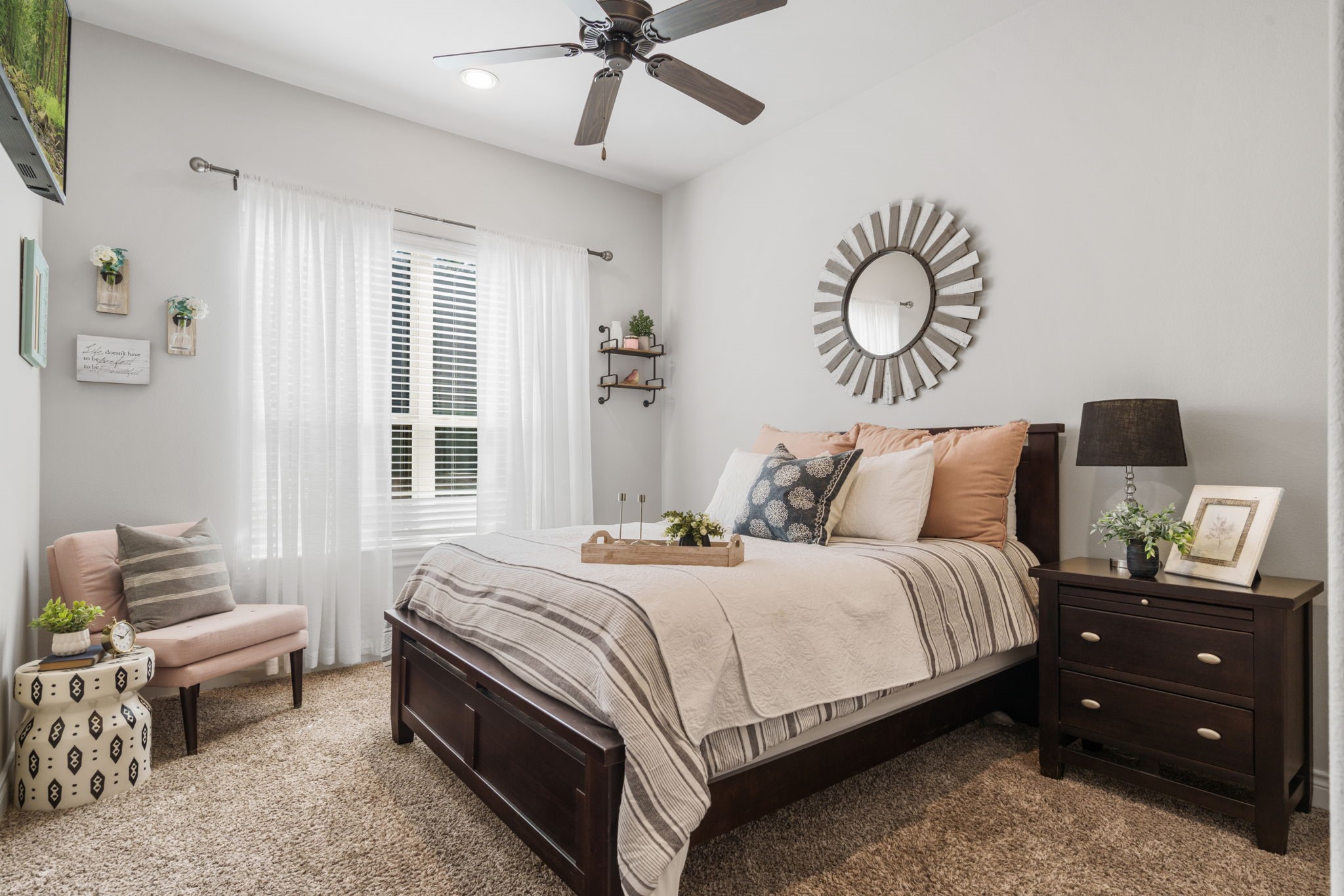 Spacious downstairs secondary bedroom with abundant natural light and convenient access to a full bathroom.