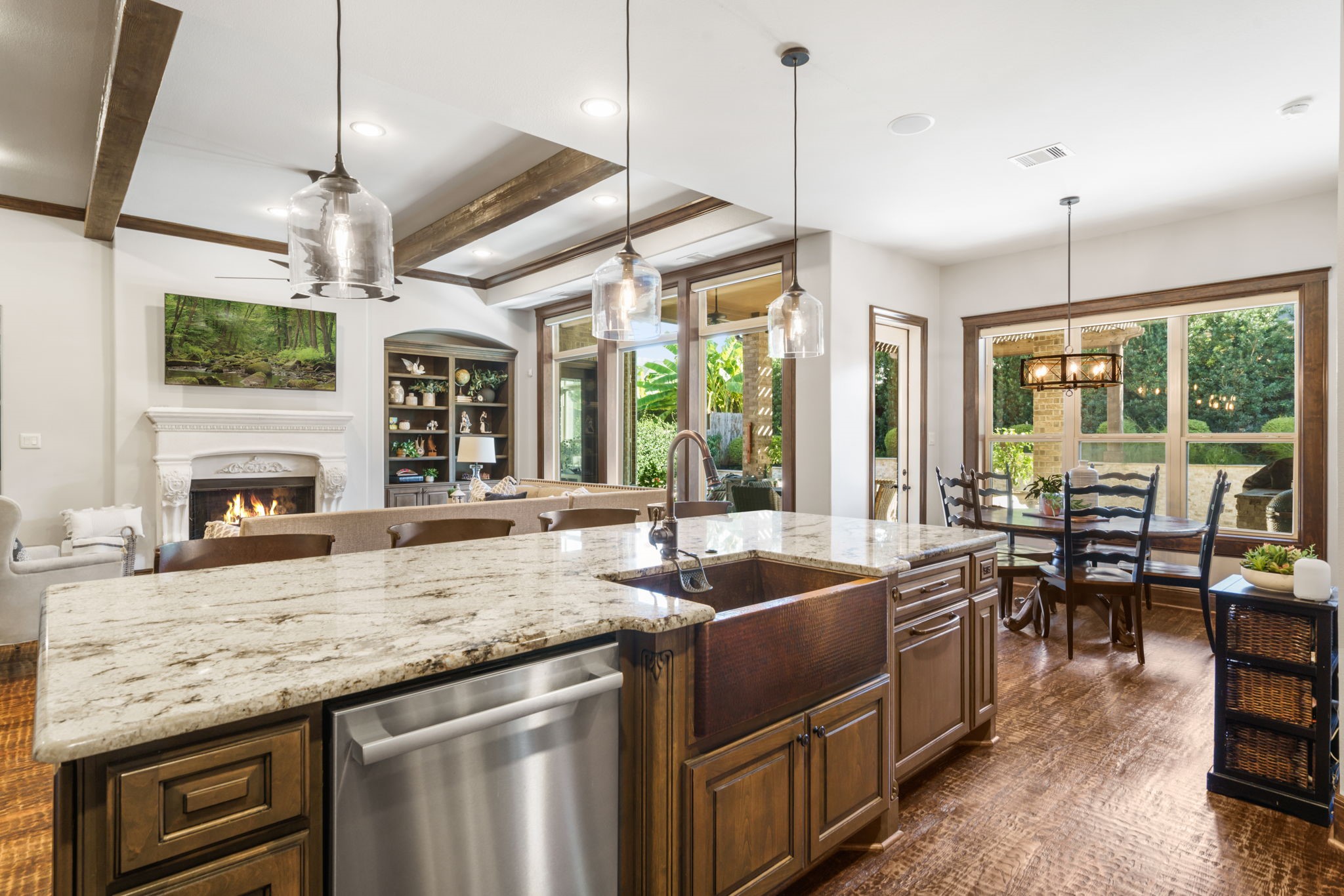 Spacious island with a distinctive farmhouse-style sink and dishwasher overlooks the family room and sunlit breakfast area.