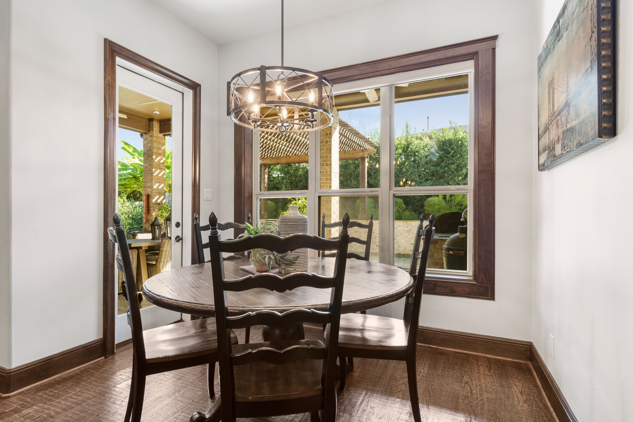 Charming breakfast area with rich wood trim, abundant natural light, and lovely views of the outdoor living space.