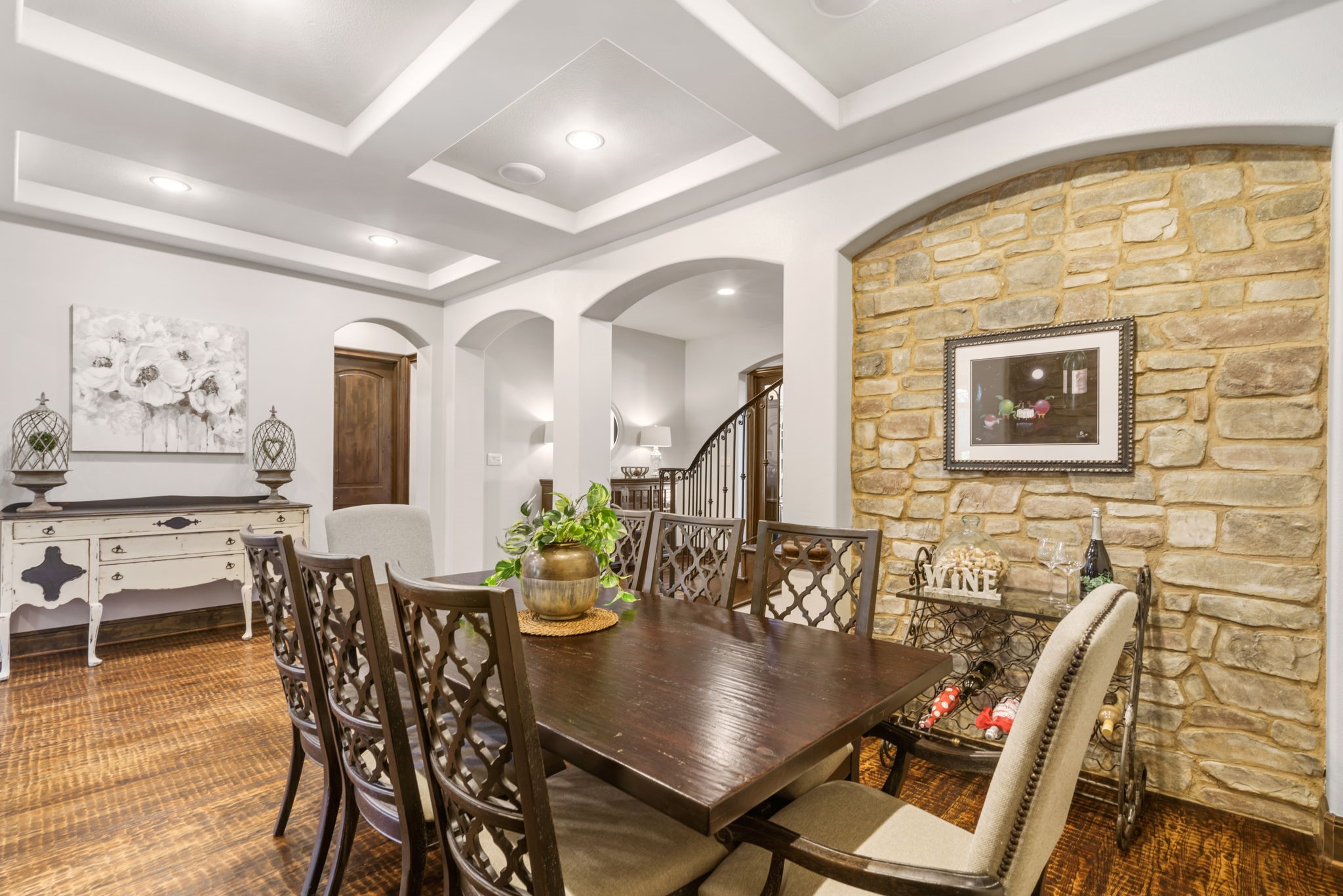 Beautiful natural stone accent walls bring warmth and texture to this inviting dining space, ideal for hosting memorable gatherings.