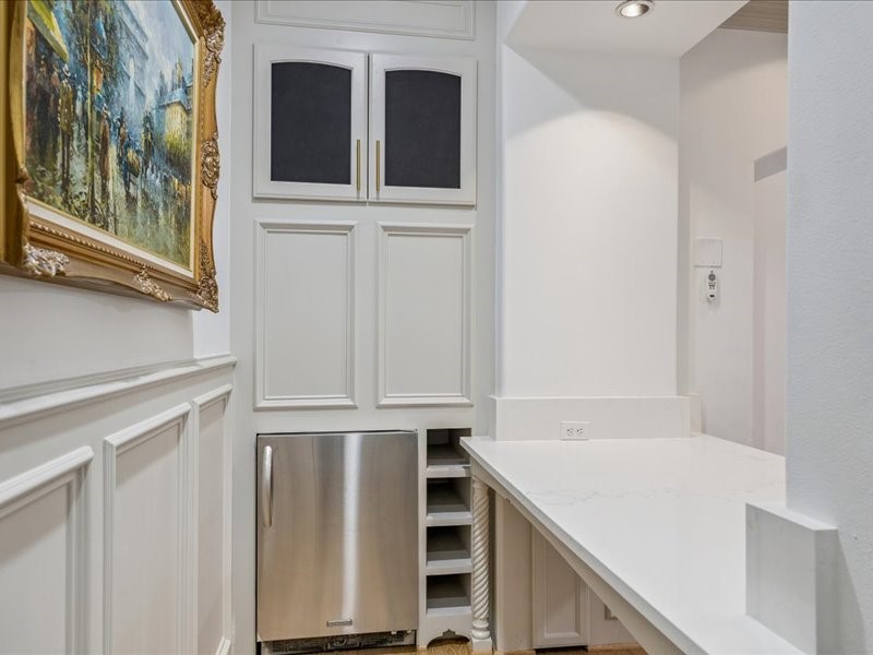 Smart design meets everyday convenience! This built-in workspace in the living area features a stainless steel beverage fridge and plenty of extra storage. Thoughtful built-ins keep essentials organized while reducing the need for additional furniture.