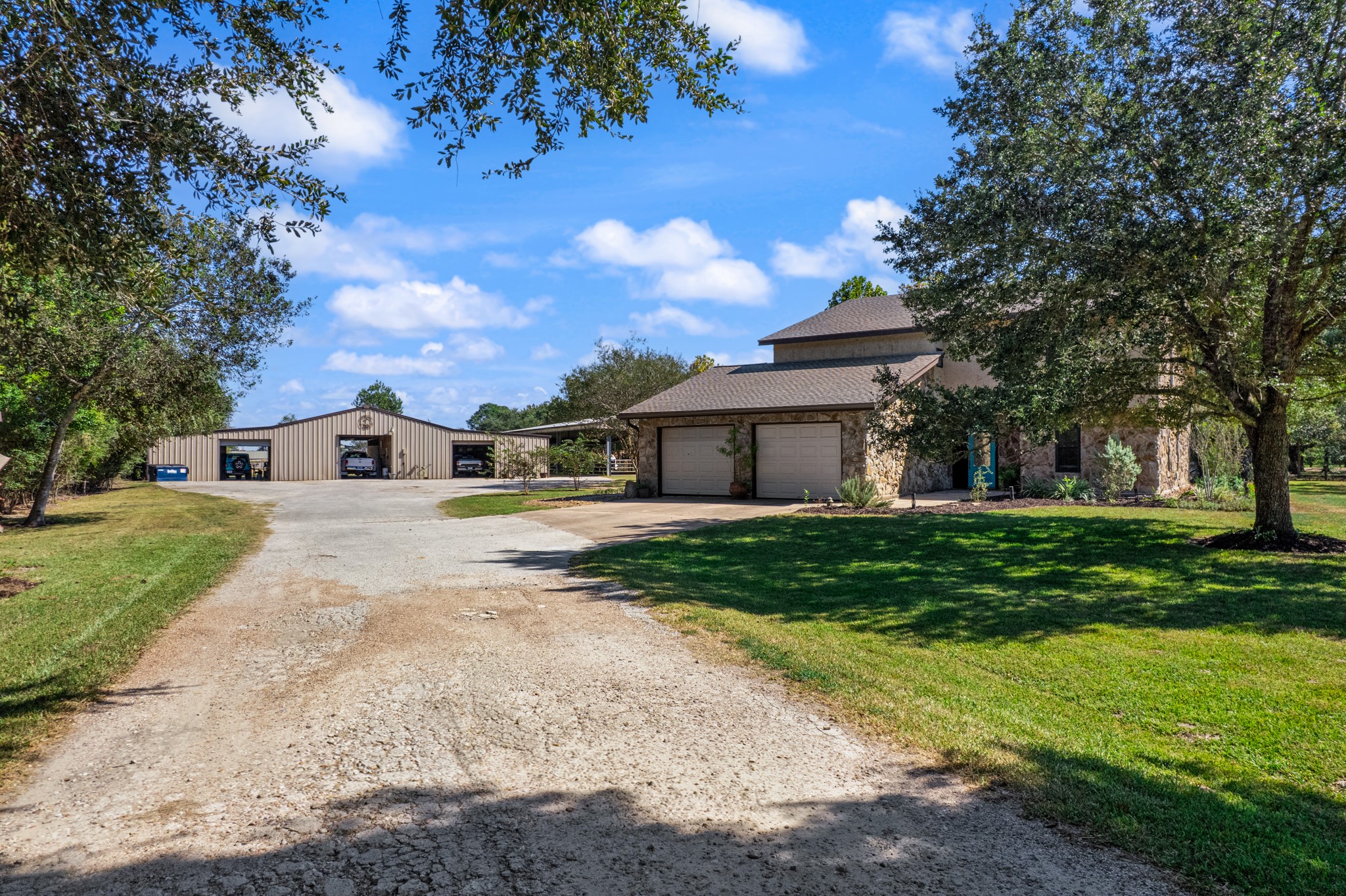 A welcoming, tree-lined driveway leads to the residence and spacious outbuildings, creating a picturesque entrance to this Santa Fe horse property. Mature shade trees, expansive lawn areas, and generous parking space complement the peaceful country setting, while the large covered structures provide convenient space for vehicles, trailers, and equestrian equipment. A welcoming, tree-lined driveway leads to the residence and spacious outbuildings, creating a picturesque entrance to this Santa Fe horse property. Mature shade trees, expansive lawn areas, and generous parking space complement the peaceful country setting, while the large covered structures provide convenient space for vehicles, trailers, and equestrian equipment.