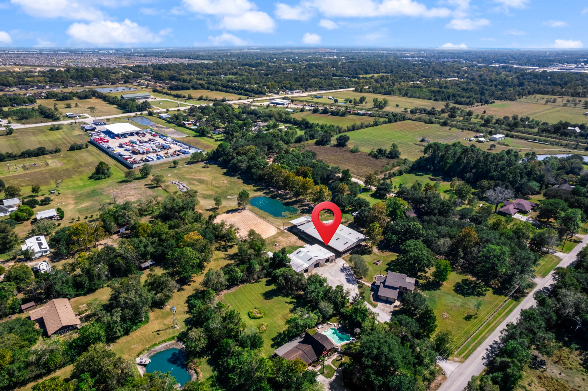 Expansive aerial view showcasing this unique Santa Fe, Texas horse property, surrounded by mature trees, open green spaces, and scenic countryside. The property's equestrian facilities, sand riding arena, and pond are visible, along with the residence and convenient access to nearby roads. A wonderful combination of country living, equestrian amenities, and accessibility to surrounding communities. Expansive aerial view showcasing this unique Santa Fe, Texas horse property, surrounded by mature trees, open green spaces, and scenic countryside. The property's equestrian facilities, sand riding arena, and pond are visible, along with the residence and convenient access to nearby roads. A wonderful combination of country living, equestrian amenities, and accessibility to surrounding communities.