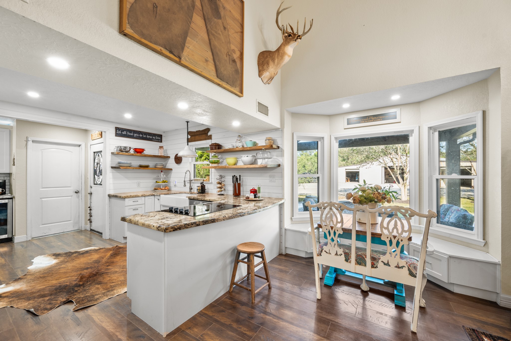 Soaring ceilings and a light-filled breakfast nook with built-in bench seating create an inviting space to gather while enjoying views of the outdoors.