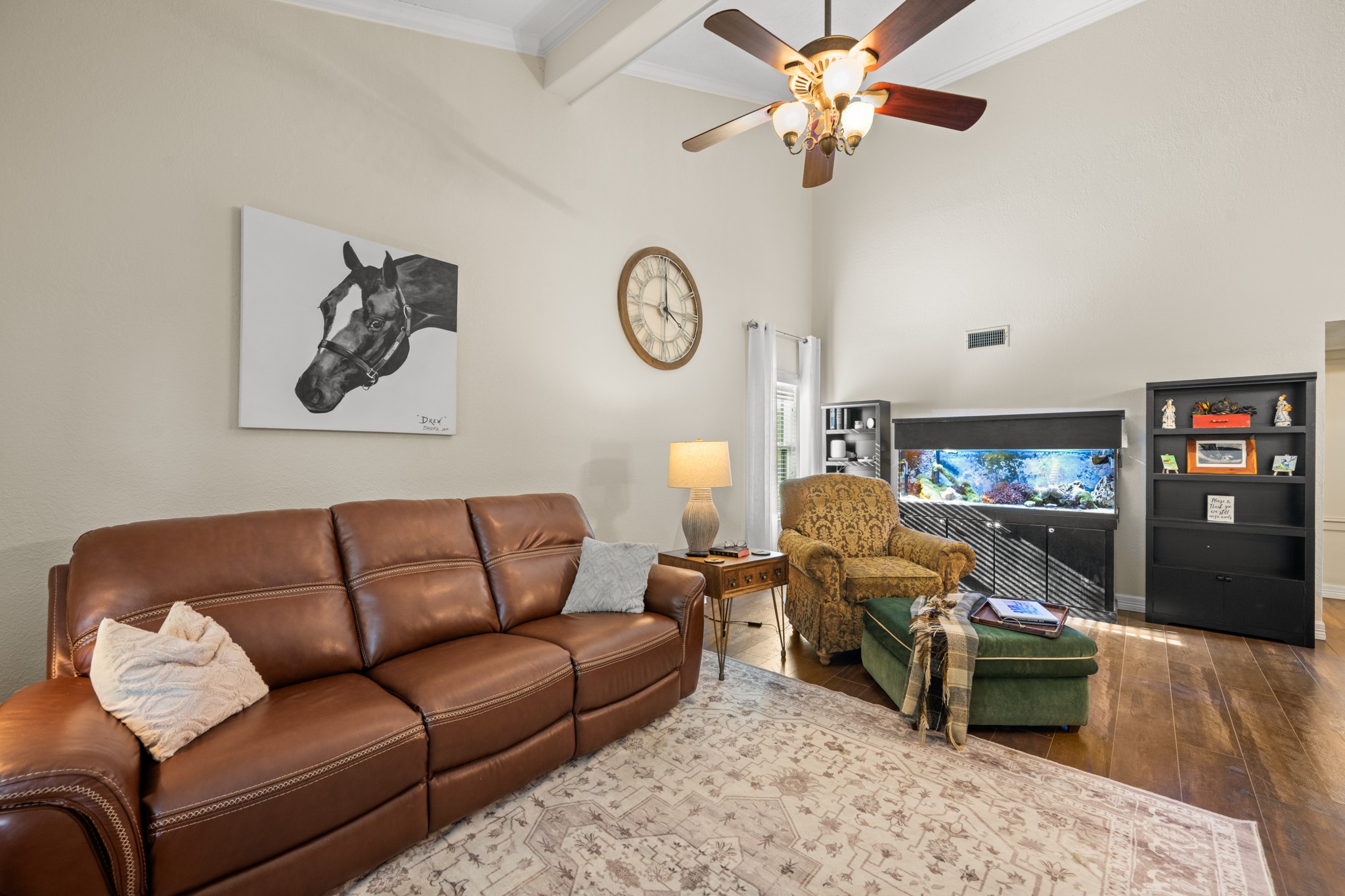 Comfortable and spacious, this inviting family room features vaulted ceilings, a ceiling fan, warm wood-look flooring, and ample room for relaxing or entertaining. Comfortable and spacious, this inviting family room features vaulted ceilings, a ceiling fan, warm wood-look flooring, and ample room for relaxing or entertaining.