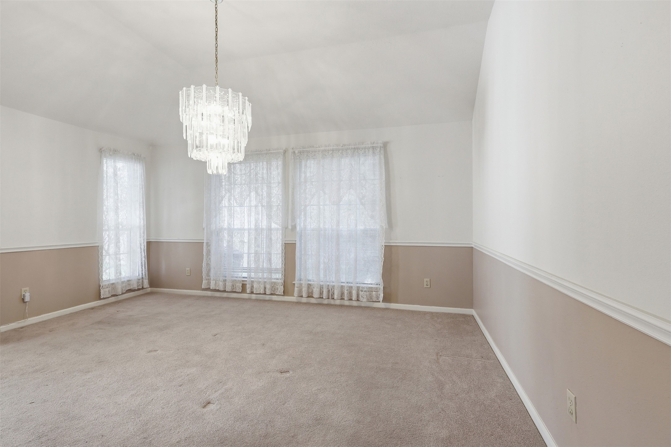 **NEW CARPET**, soft natural light, and an elegant chandelier create the perfect setting for meals and gatherings