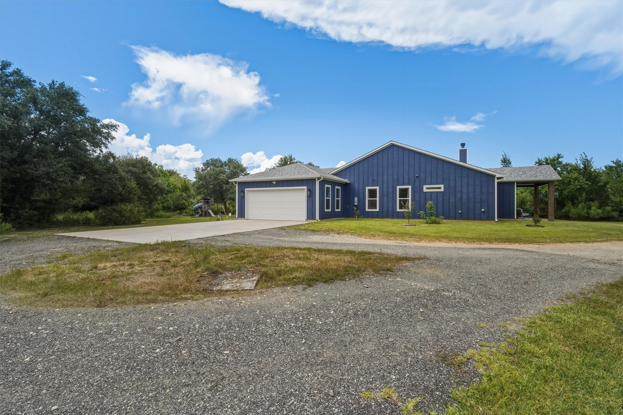 Private drive leads to circle drive between the oversized garage and RV hookup