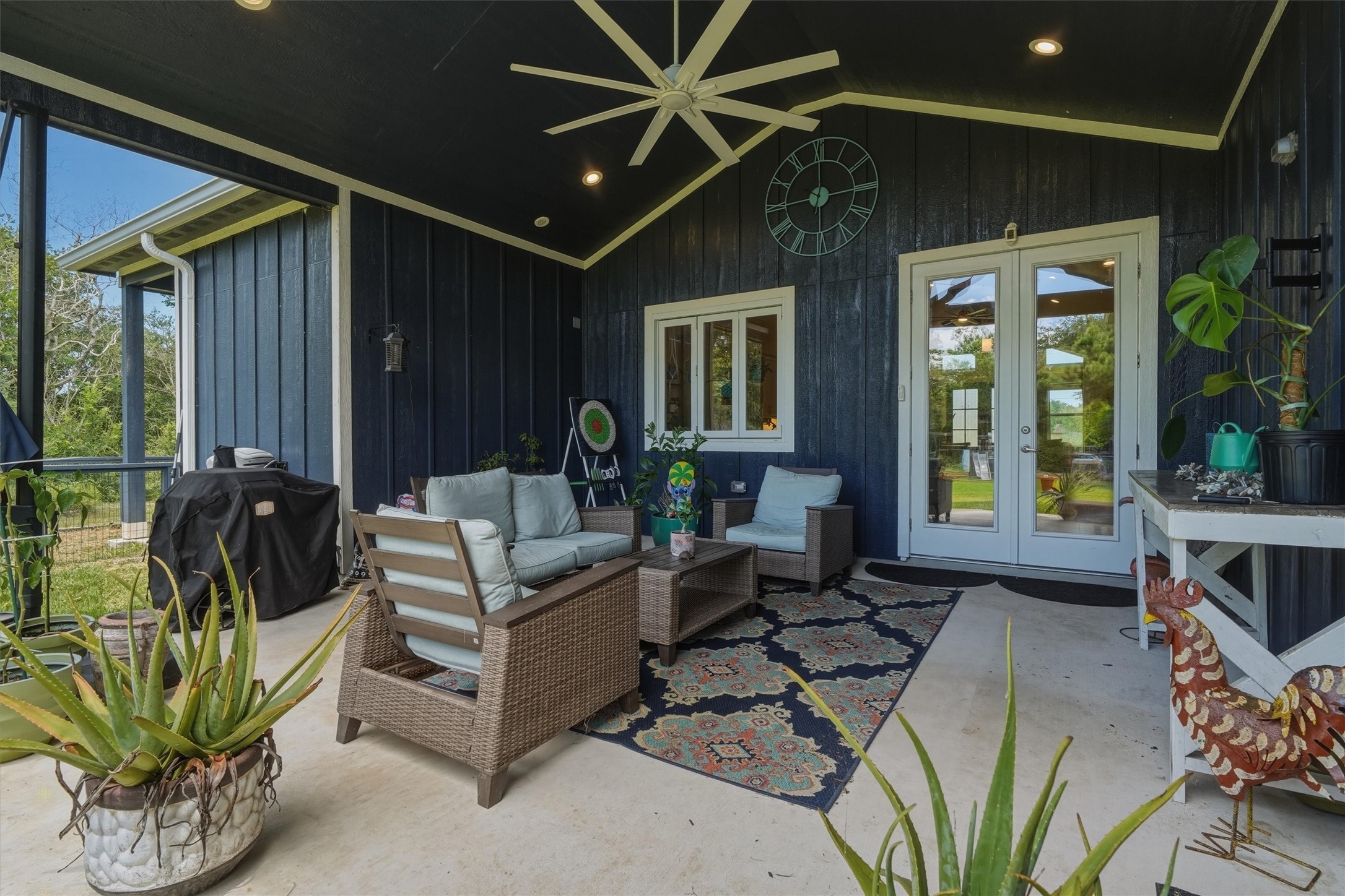 Beautiful covered back patio with large fan to beat the Texas Heat! Accordion windows between kitchen and patio.