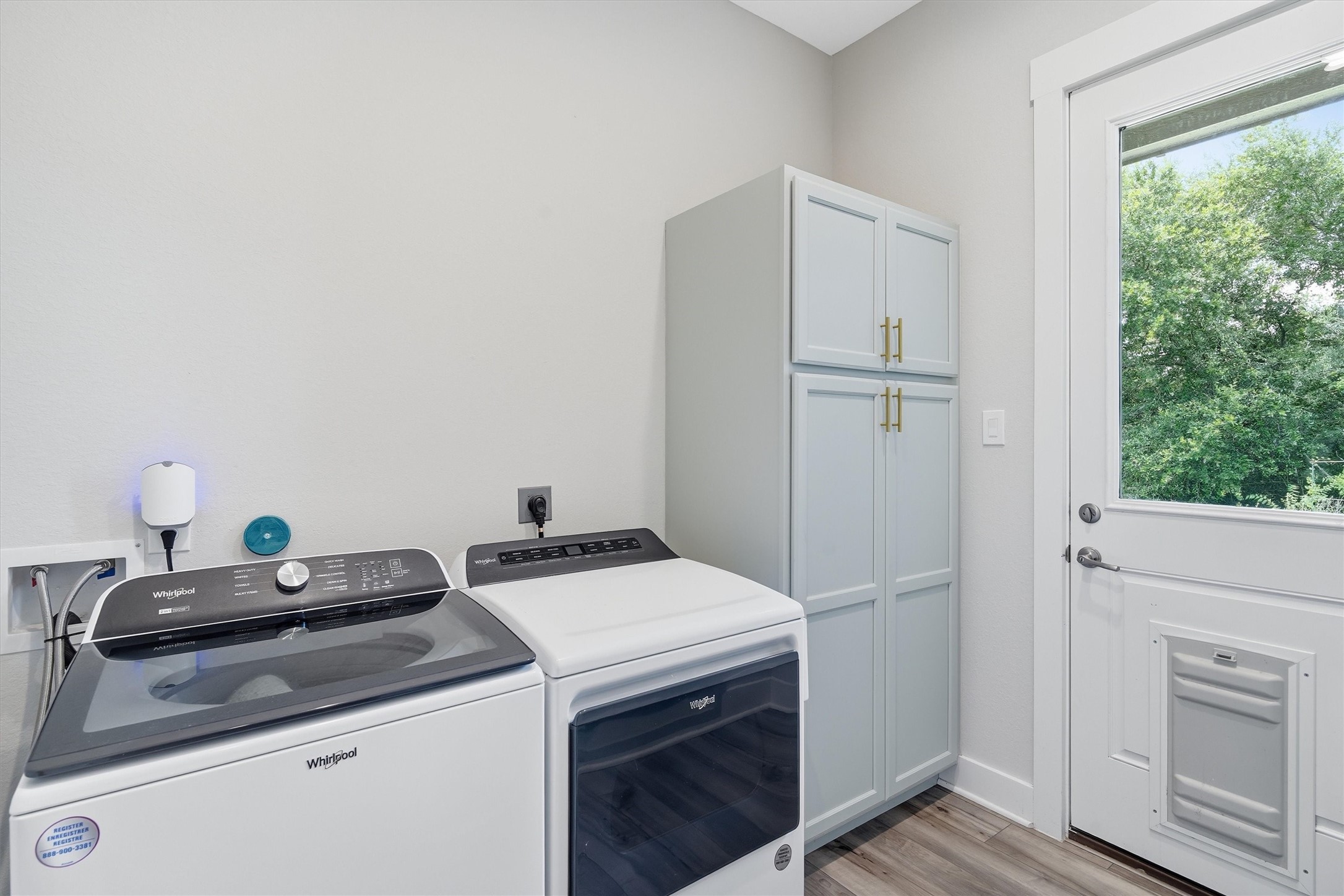 Large laundry room with built ins, dog wash and outdoor access to the pet run.